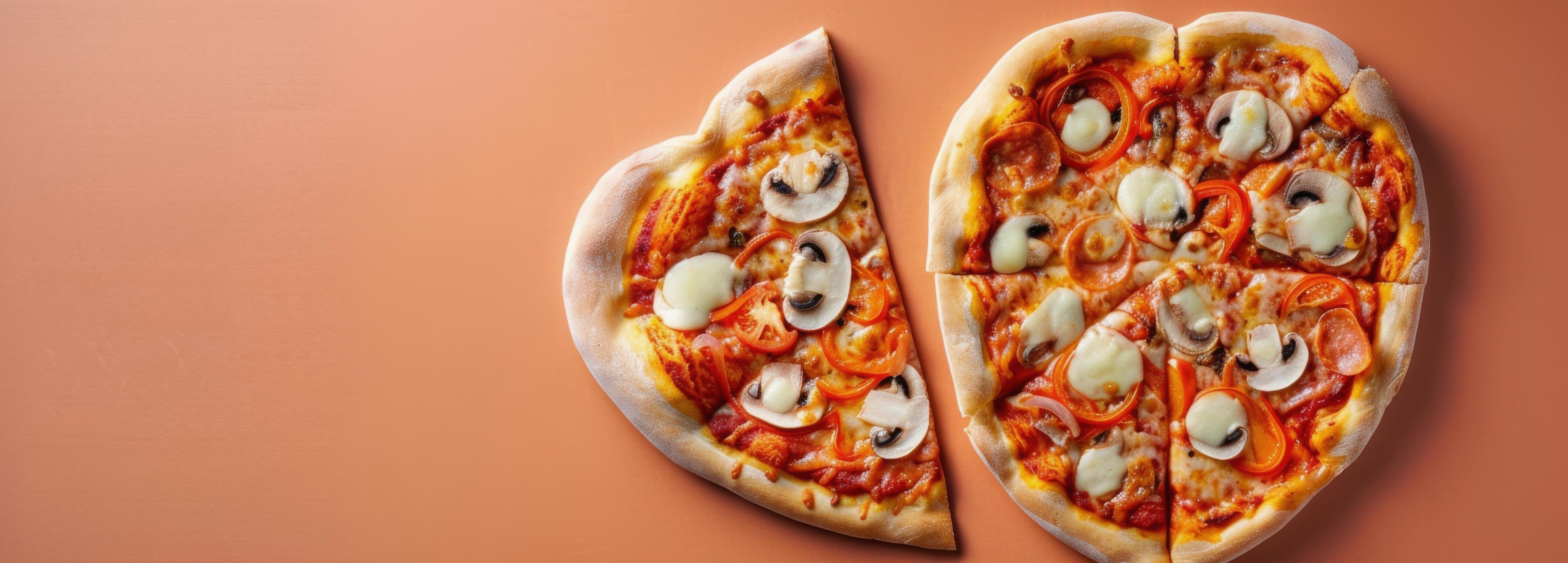 
									Heart-Shaped Pizza With Toppings Cut Into Slices On A Orange Background Stock Free