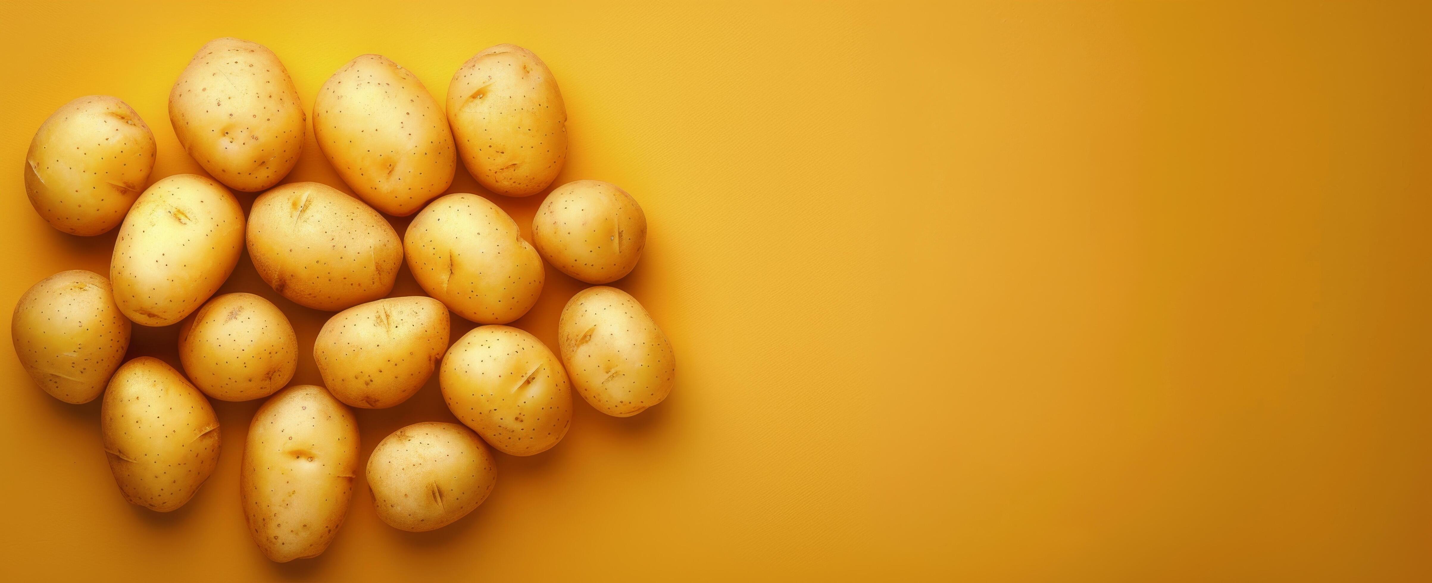 Fresh Potatoes on Yellow Background in Natural Light Stock Free