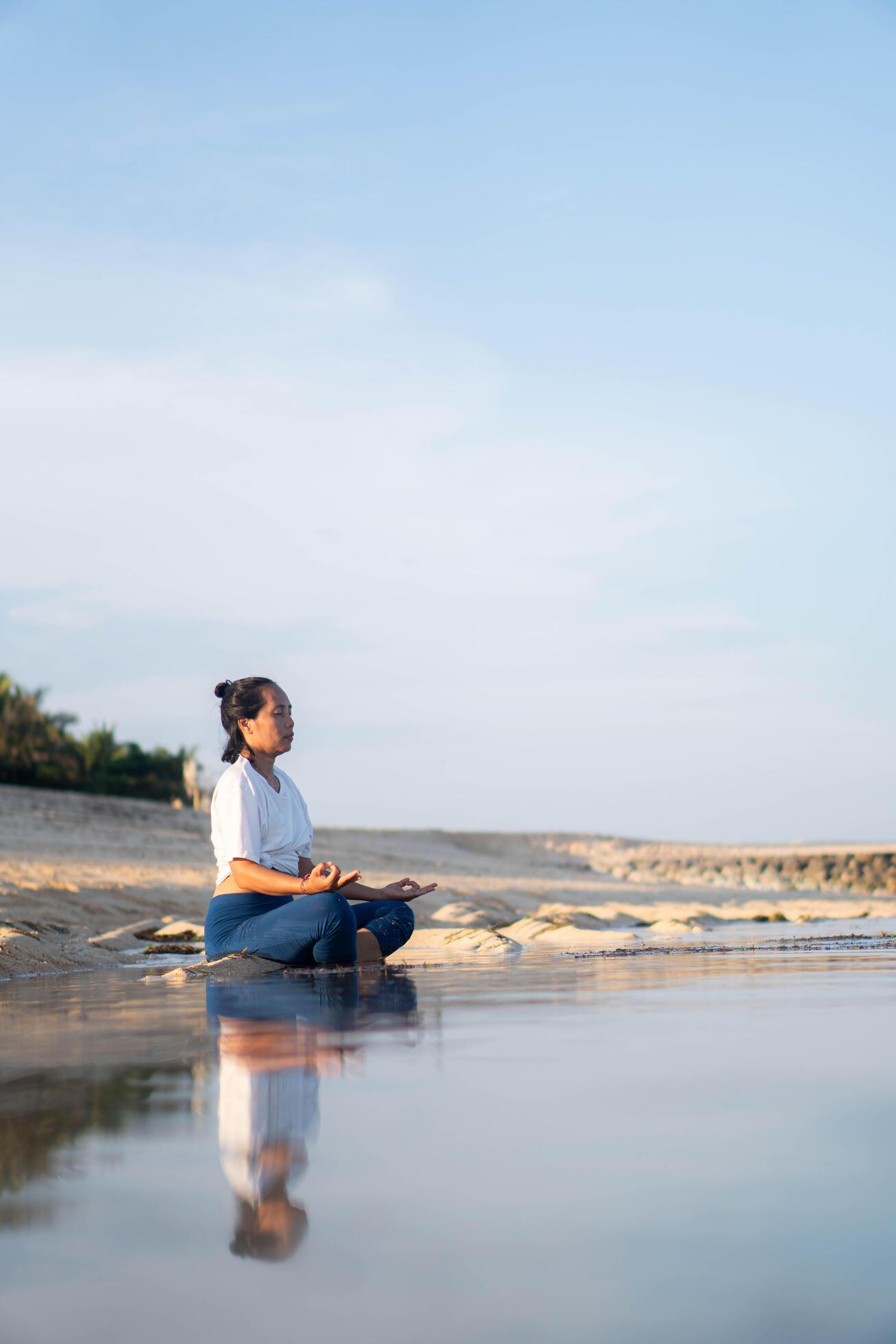 healthy woman with beautiful body doing yoga at sunrise on the beach, yoga poses Stock Free