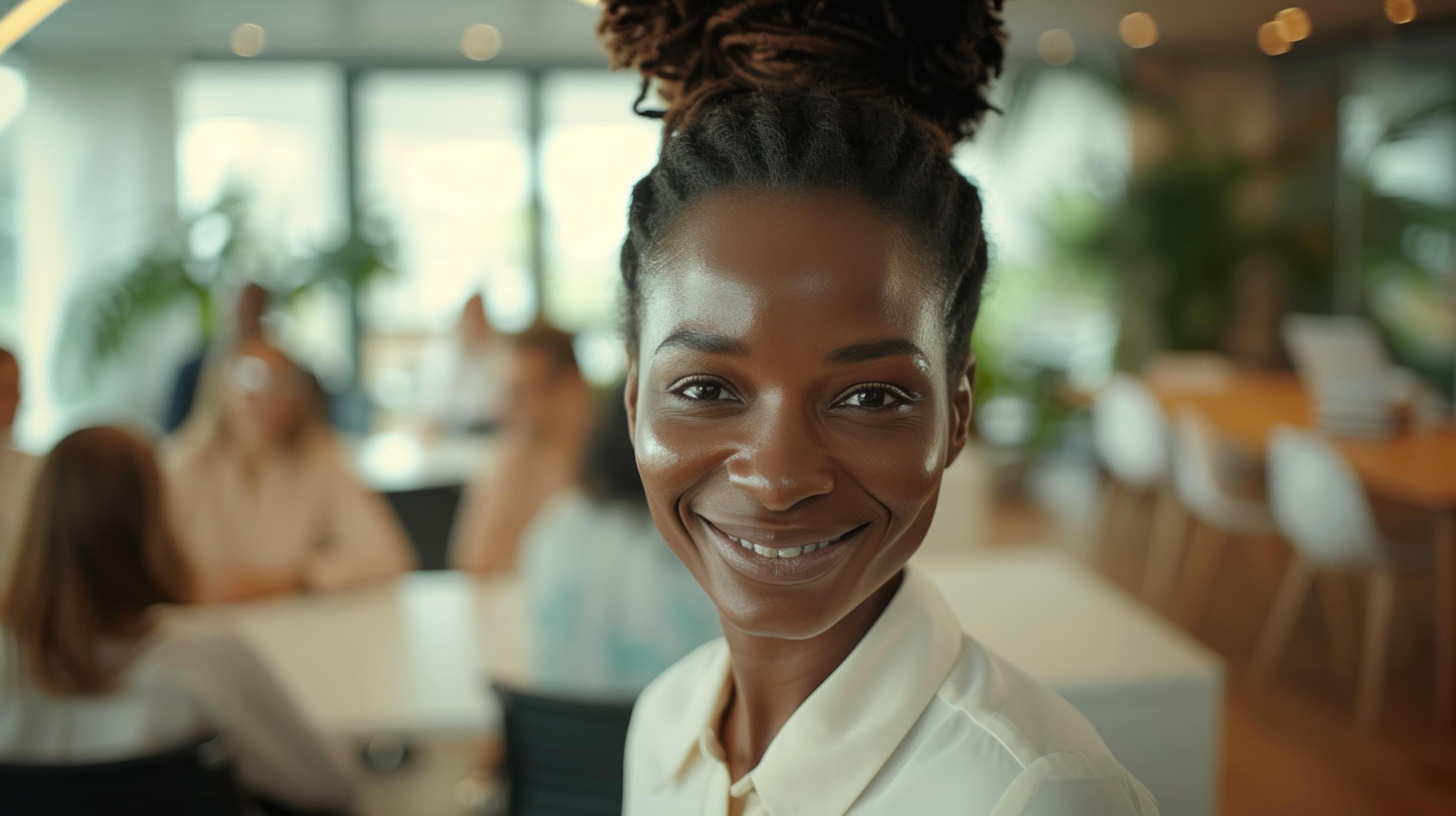 AI generated A smiling and confident business leader gazes at the camera while standing in an office during a team meeting Stock Free