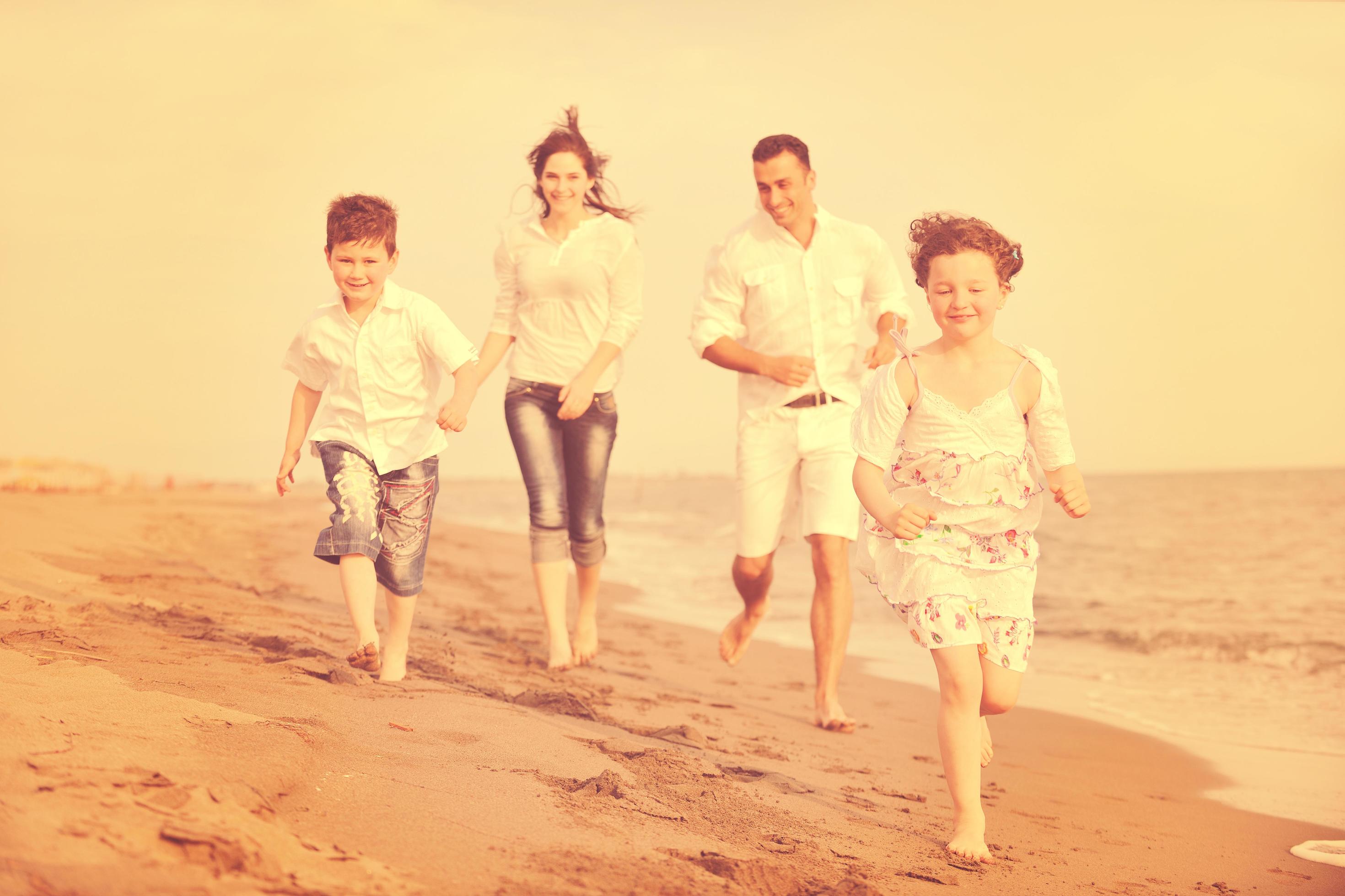 happy young family have fun on beach Stock Free