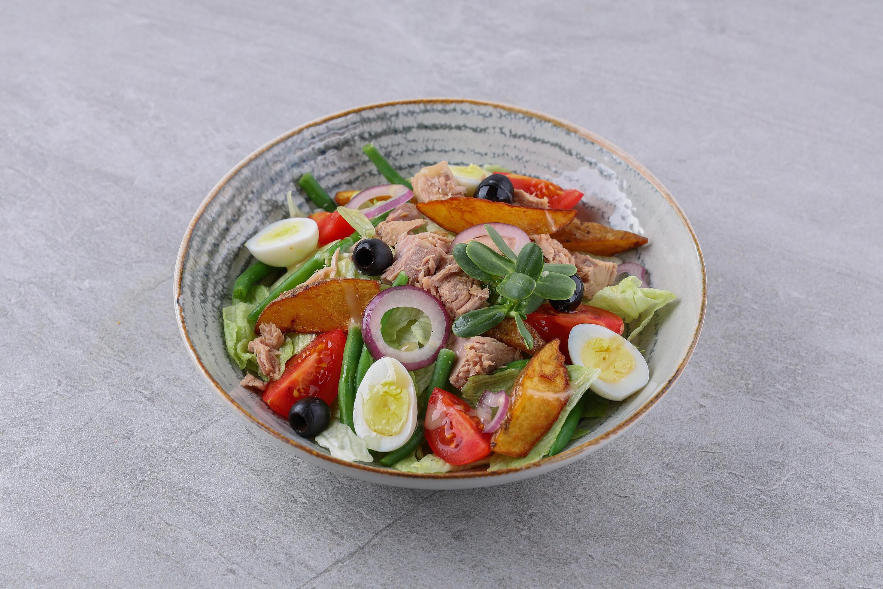 salad with tuna, quail eggs and baked potatoes on a stone background, studio food photography 4 Stock Free