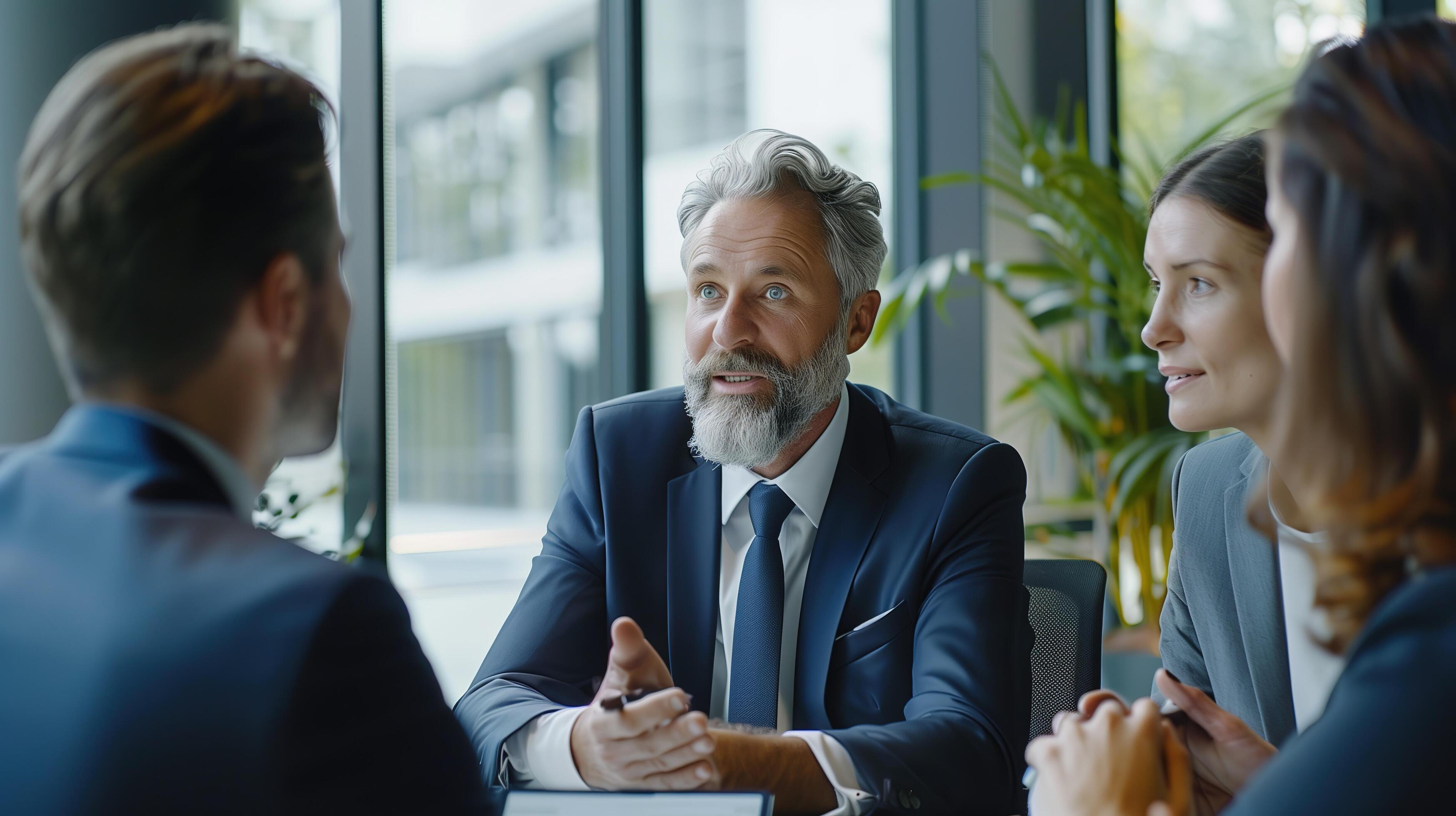 A confident financial advisor explaining investment options to attentive clients in a sleek, professional office environment Stock Free