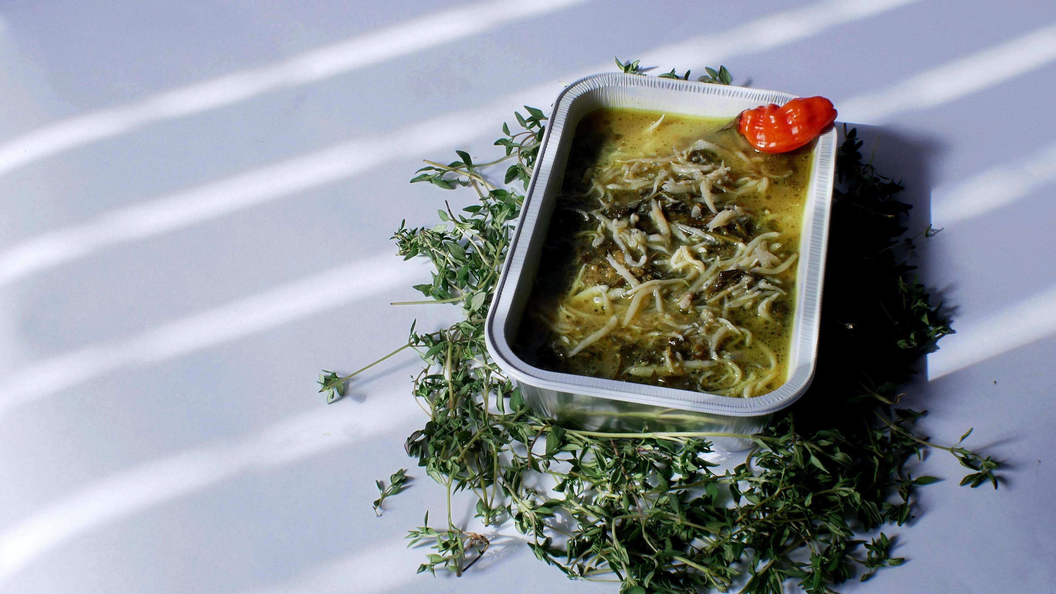 cassava leaf vegetable with anchovies Indonesian food served in an aluminum container with a white background Stock Free