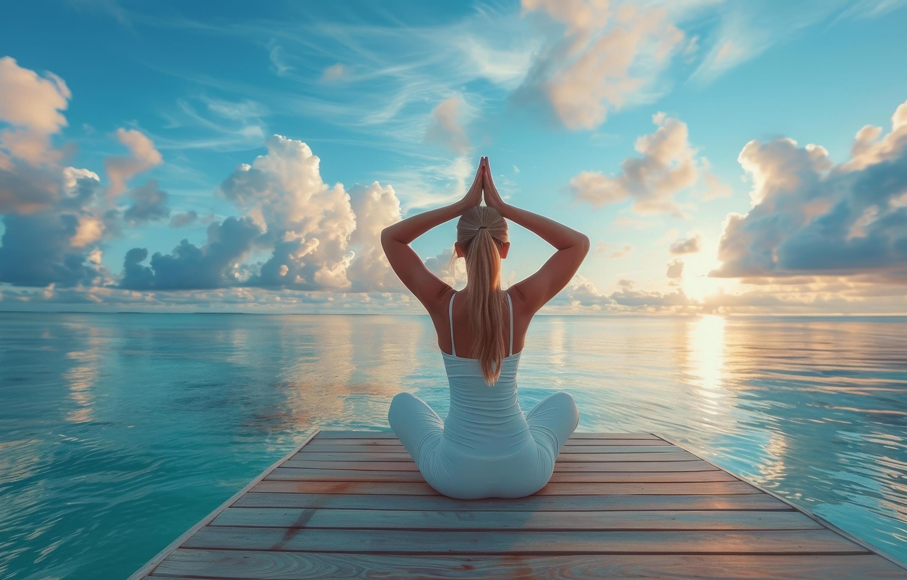 Woman Practicing Yoga on Wooden Dock During Sunrise at the Beach Stock Free