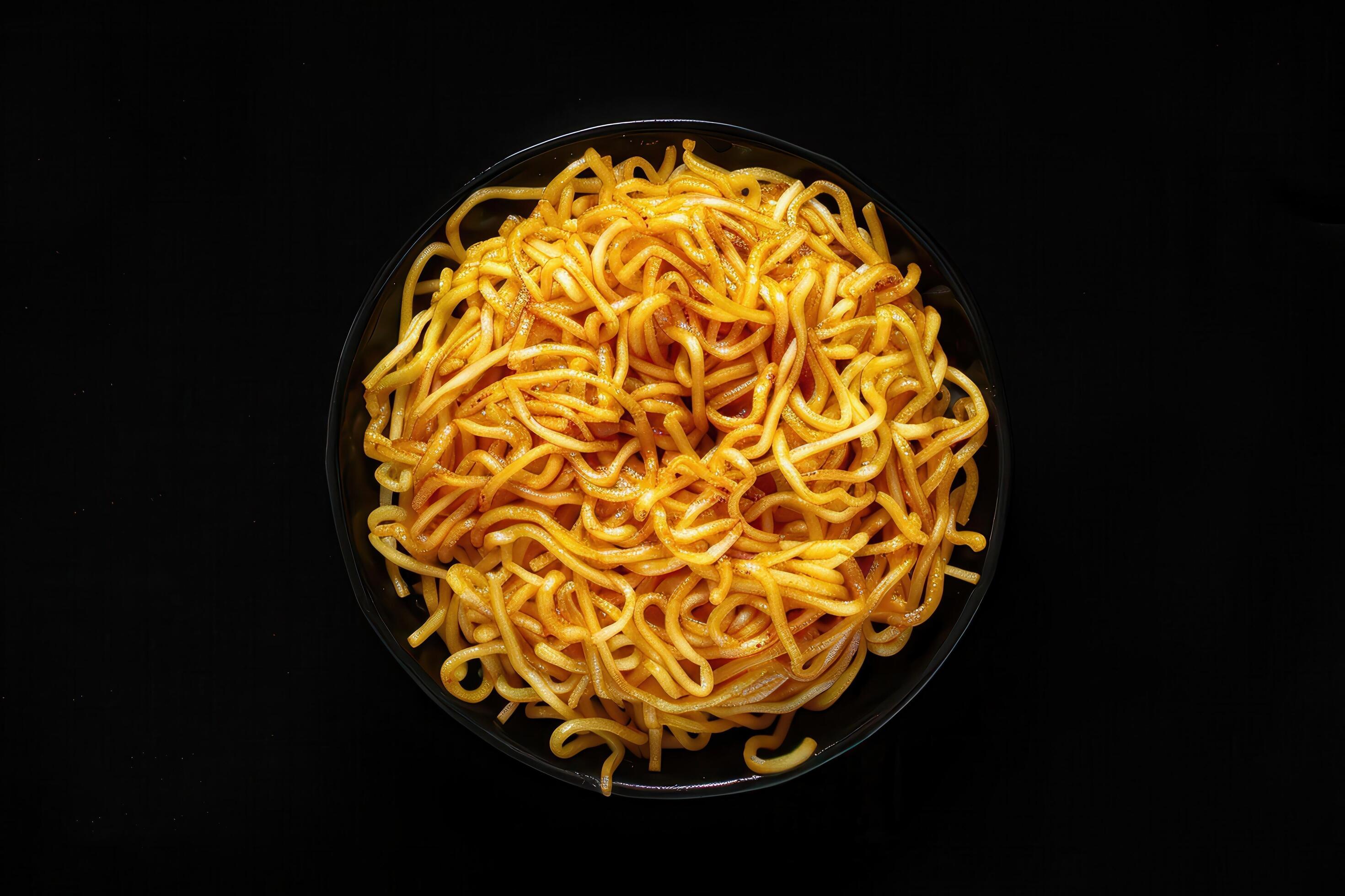 Close-up of a Bowl of Cooked Noodles on a Black Background Stock Free