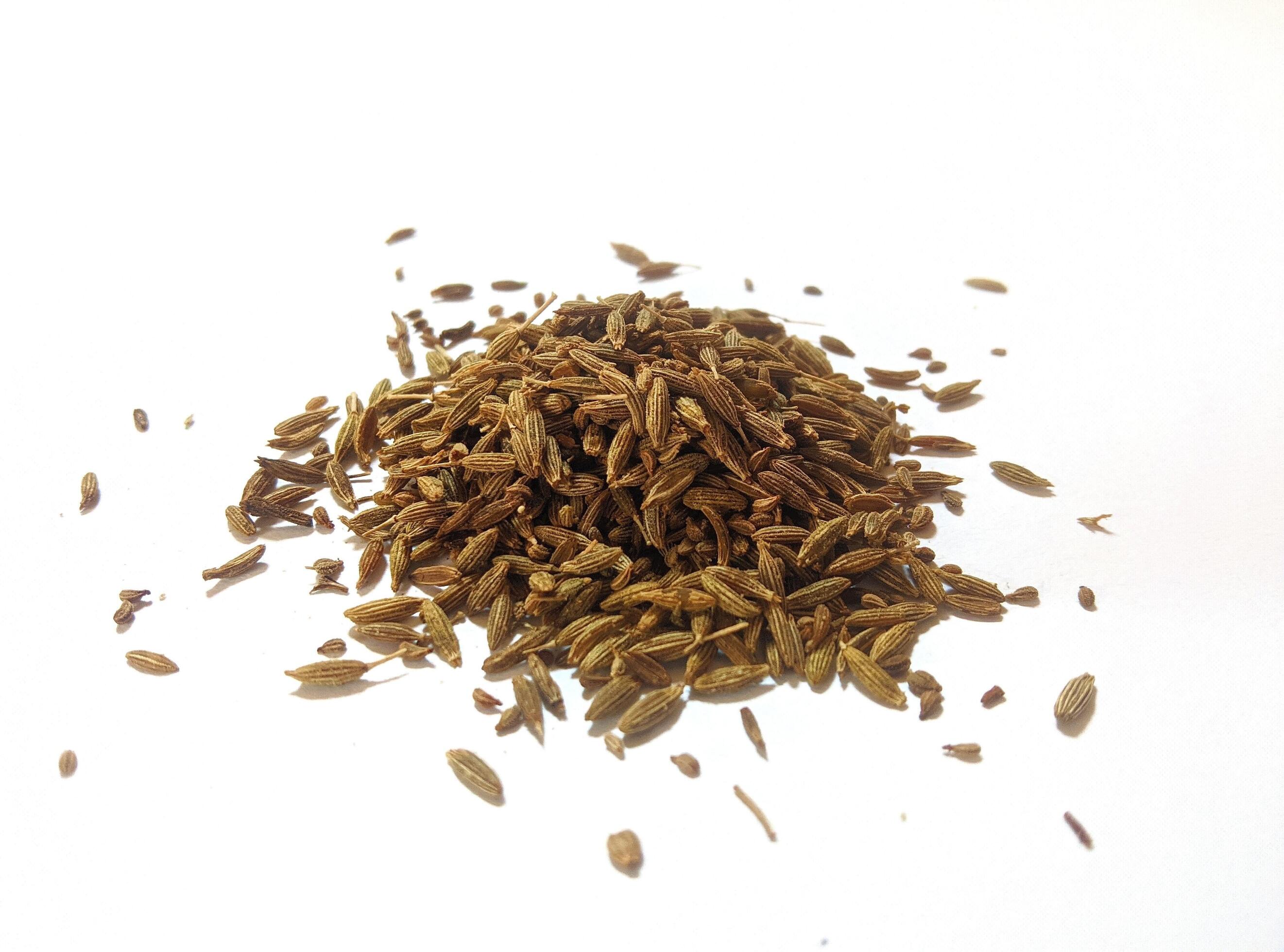 Pile of cumin seeds isolated on white background Stock Free