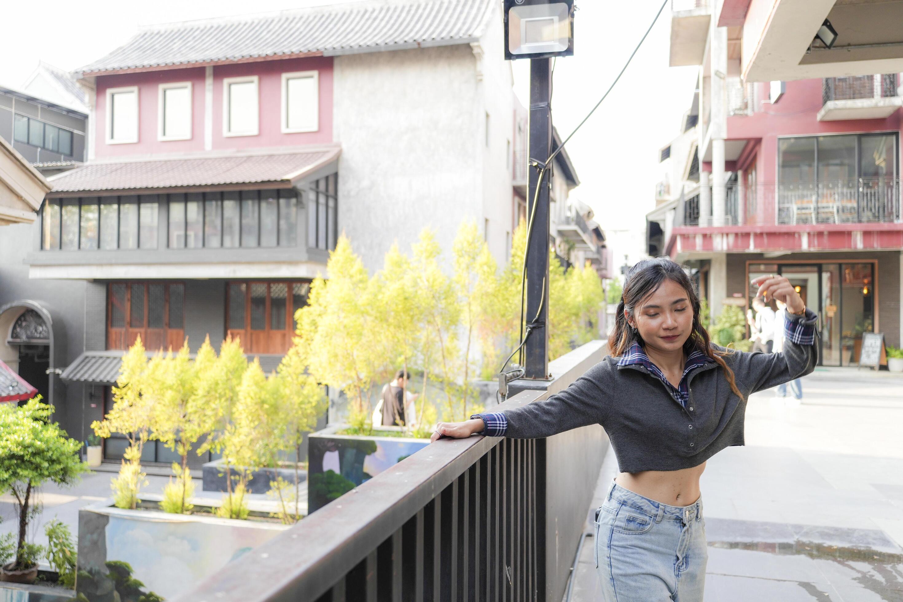 Asian women do freestyle hip hop and breakdancing in a public space in the middle of the city. With a cheerful and happy attitude Stock Free