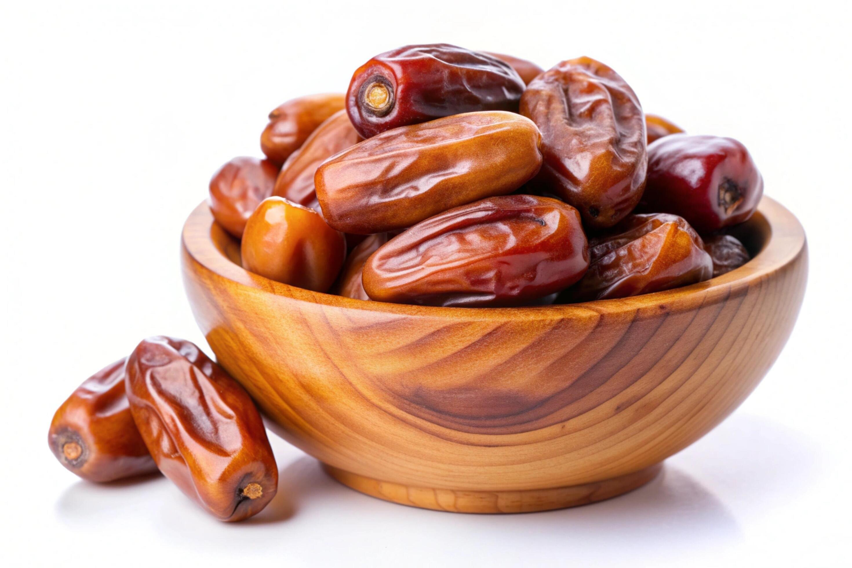 Dates in wood bowl isolated on white background Stock Free