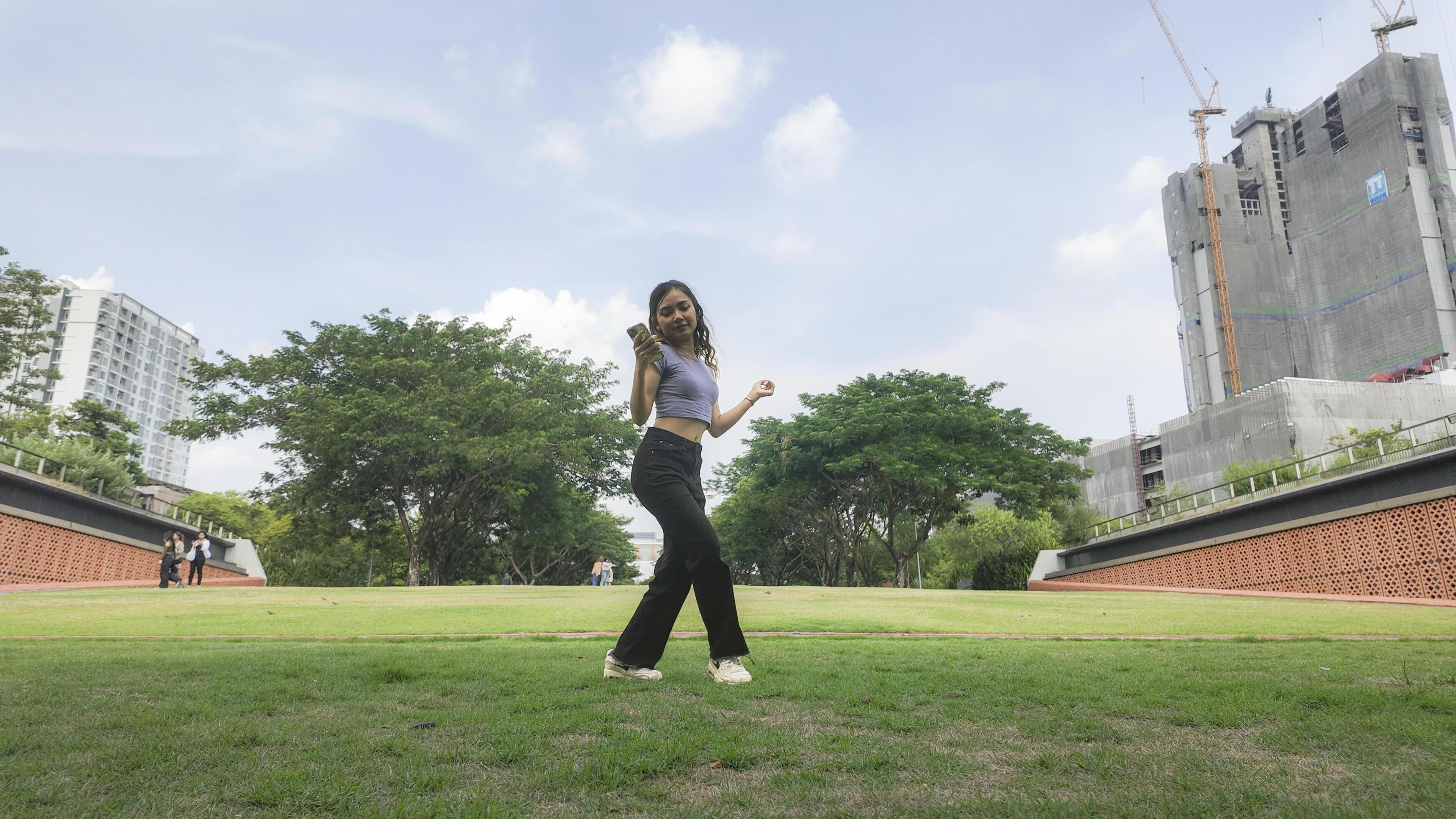 Asian women do freestyle hip hop and breakdancing in a public space in the middle of the city. With a cheerful and happy attitude Stock Free