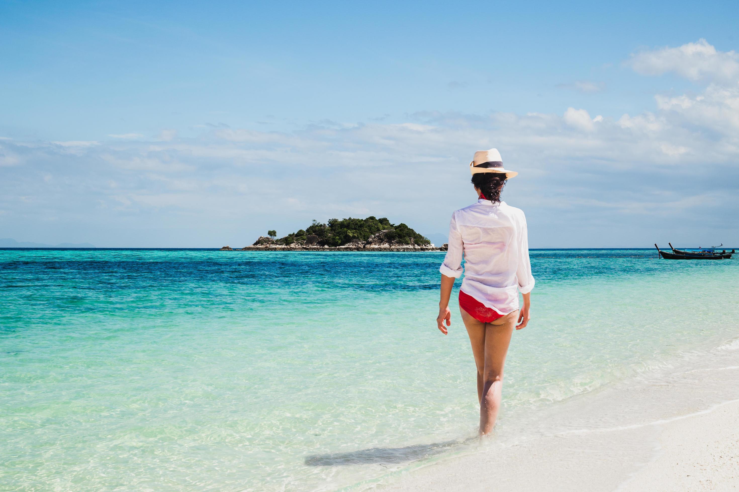 Woman relaxing walking on the beach in tropical island. Stock Free