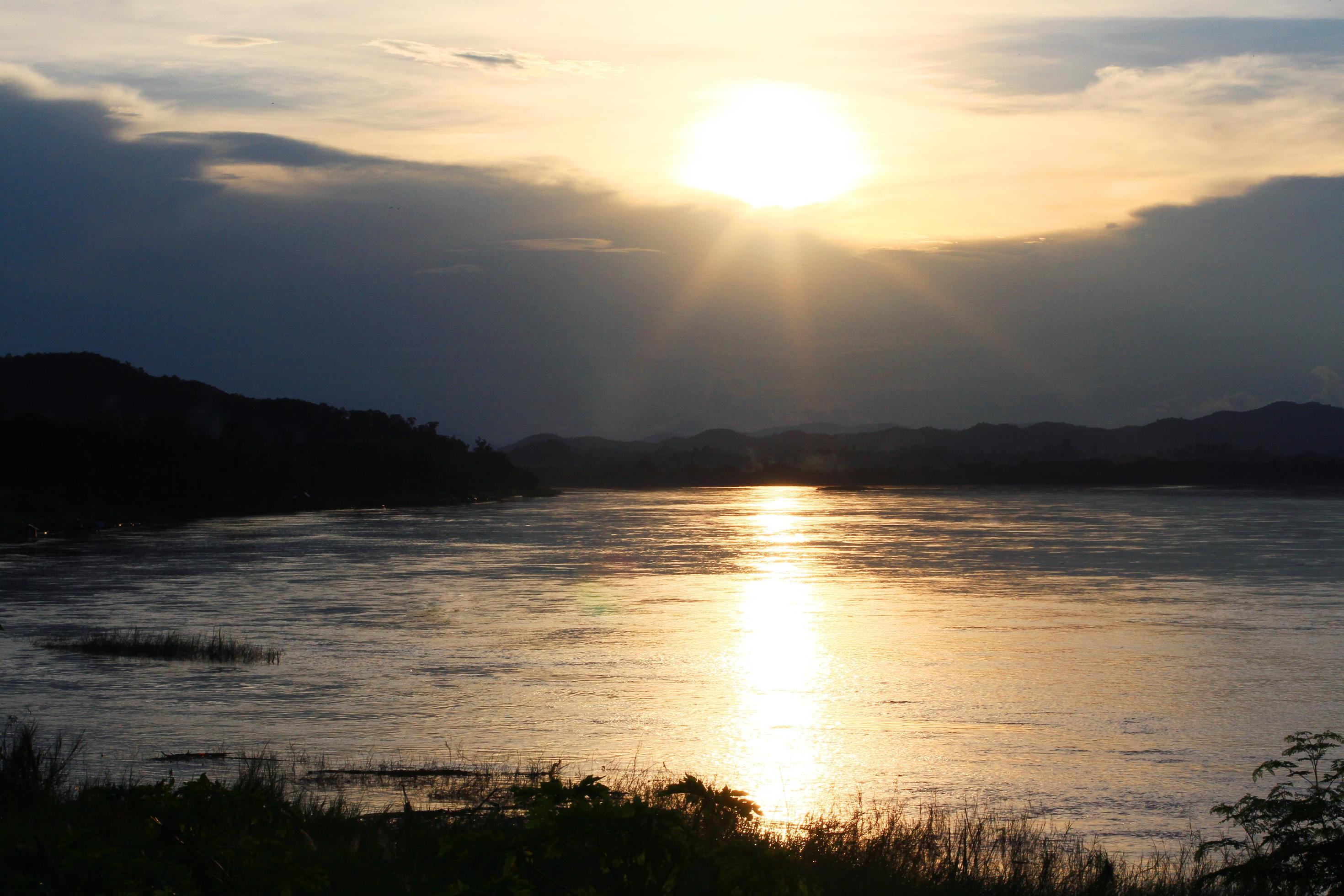 Tradition of Long tail boat and fisherman in sunset twilight at Khong river the Thai-Laos border Chaingkhan distric Thailand Stock Free