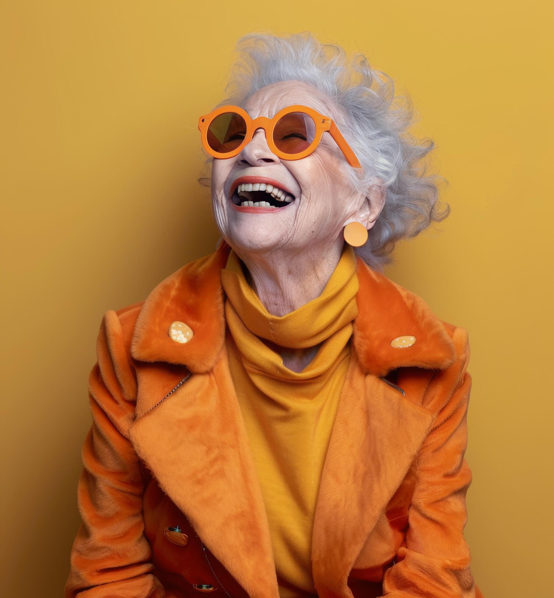 Smiling Senior Woman In Yellow Coat And Sunglasses Against Yellow Background Stock Free