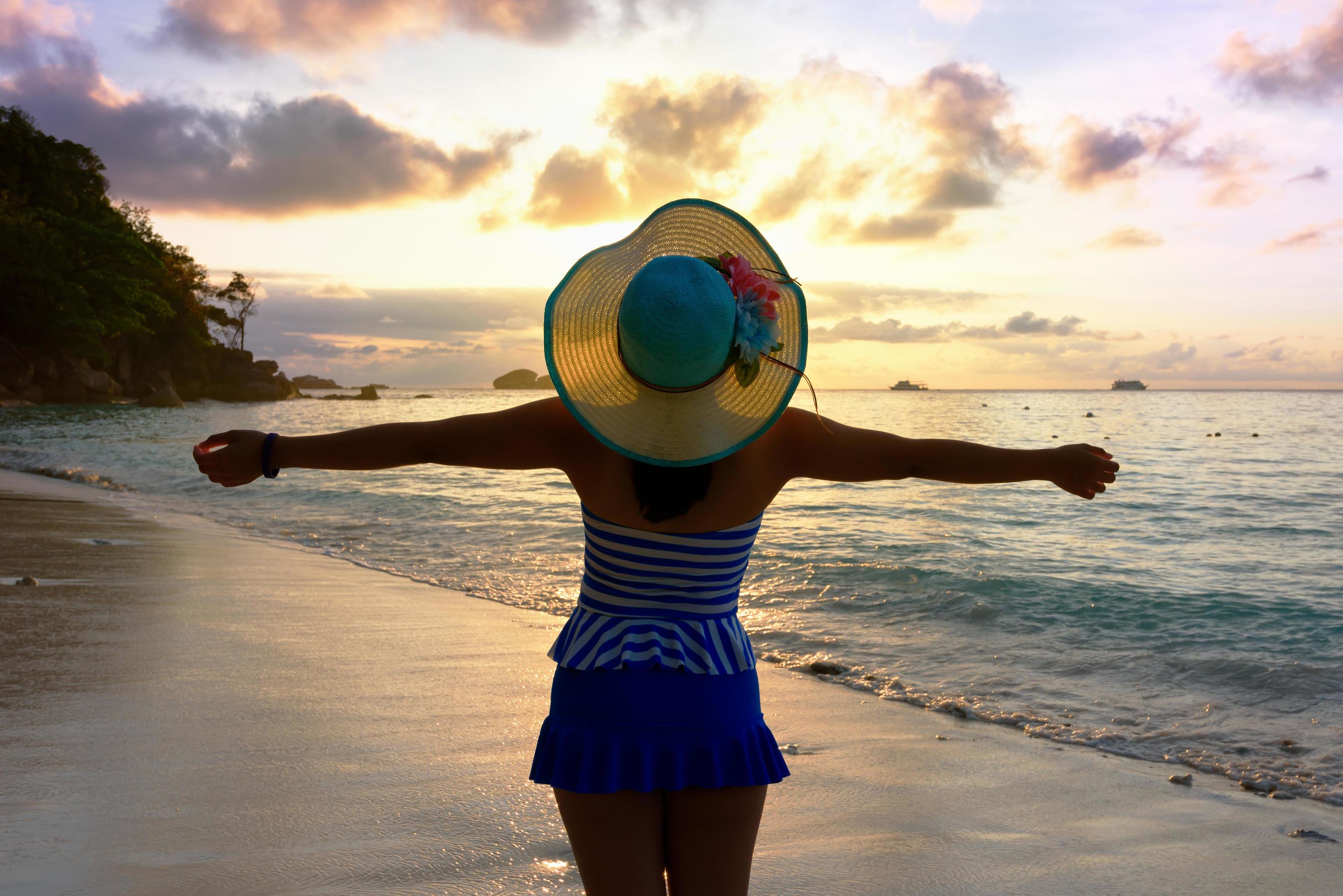 Happy girl on the beach at sunrise Stock Free