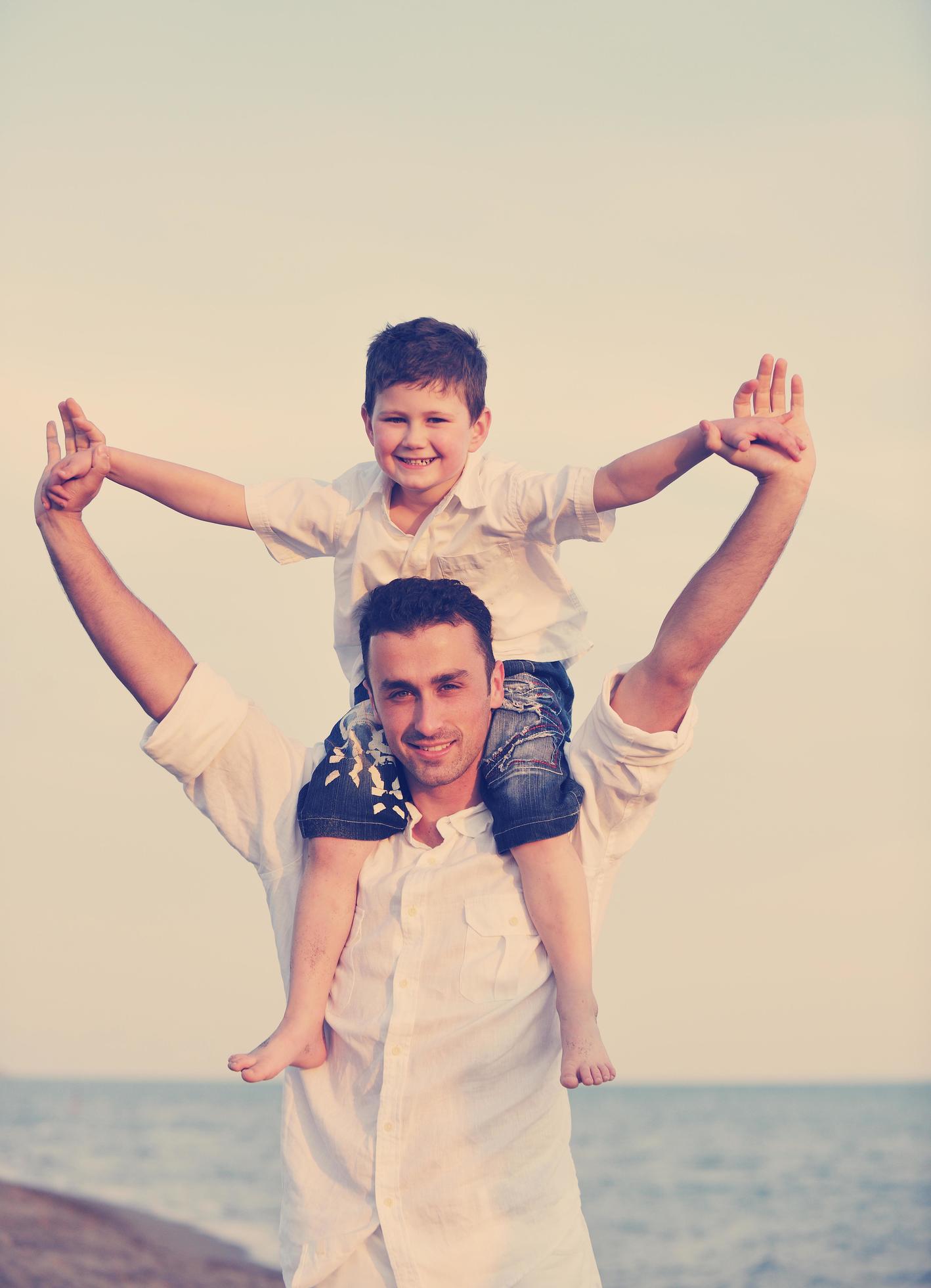 happy young family have fun on beach Stock Free