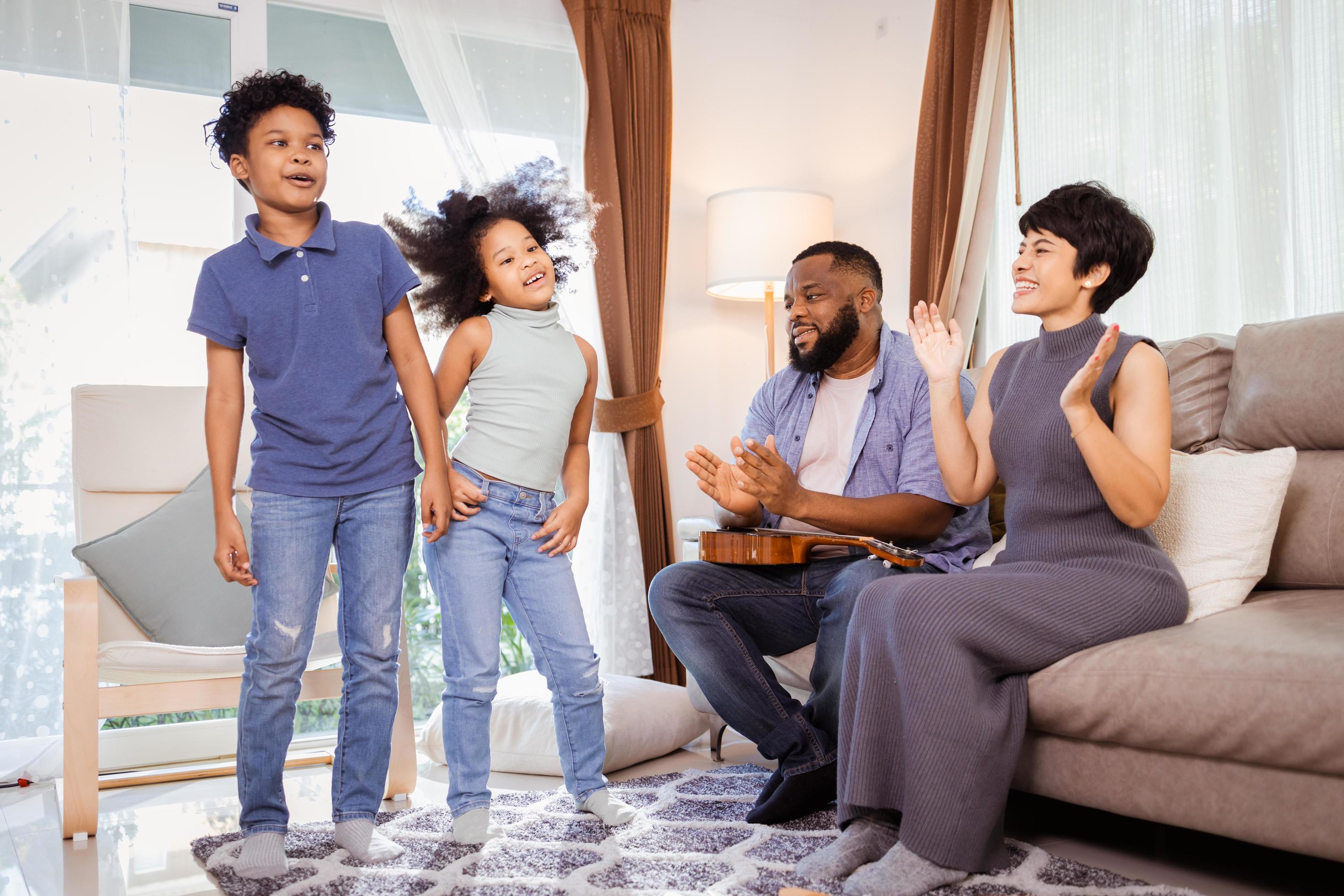 Smiling Family with Kids Dancing at Home, Great for Family Blogs and Magazines Stock Free