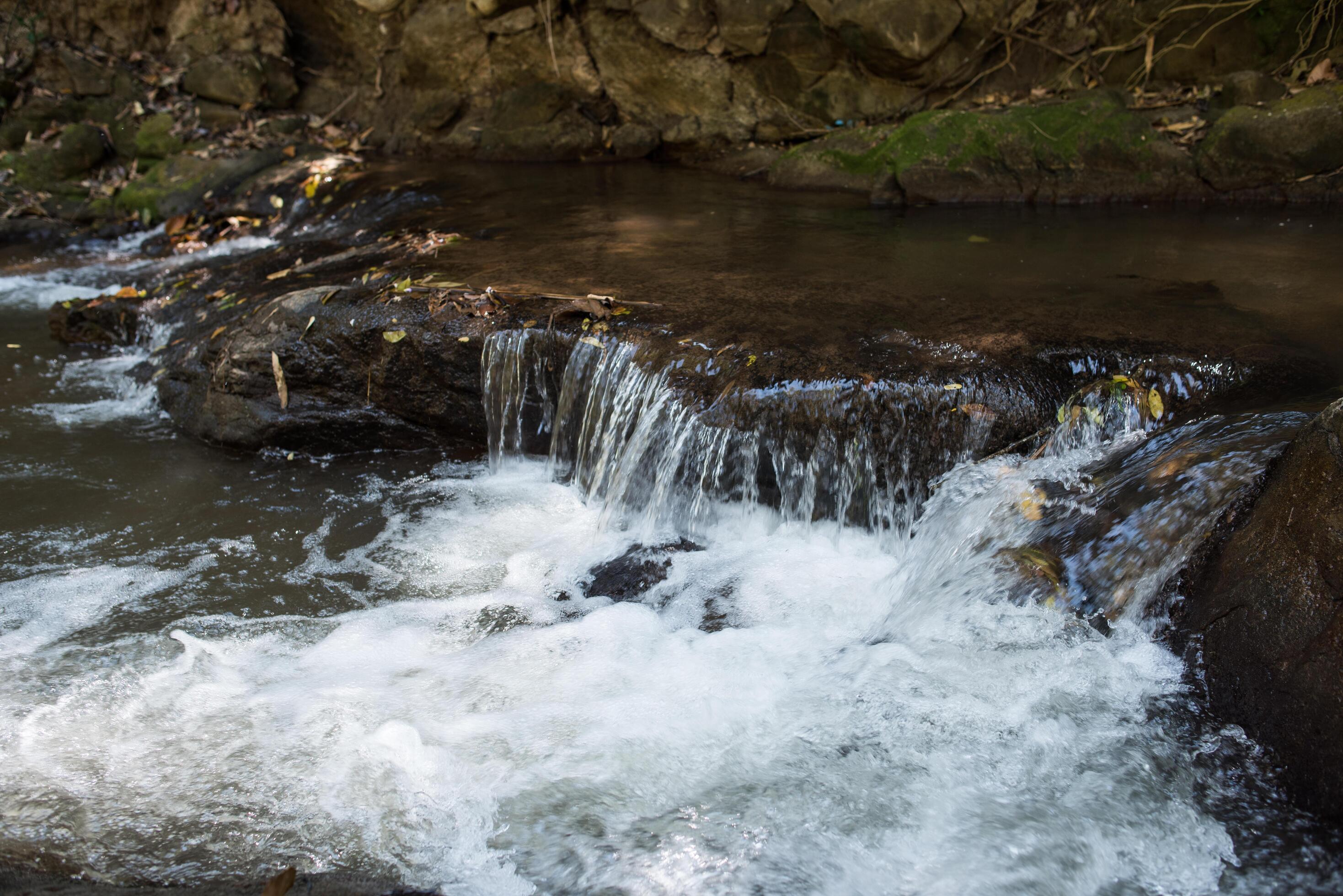 Waterfall in the nature and stone background Stock Free