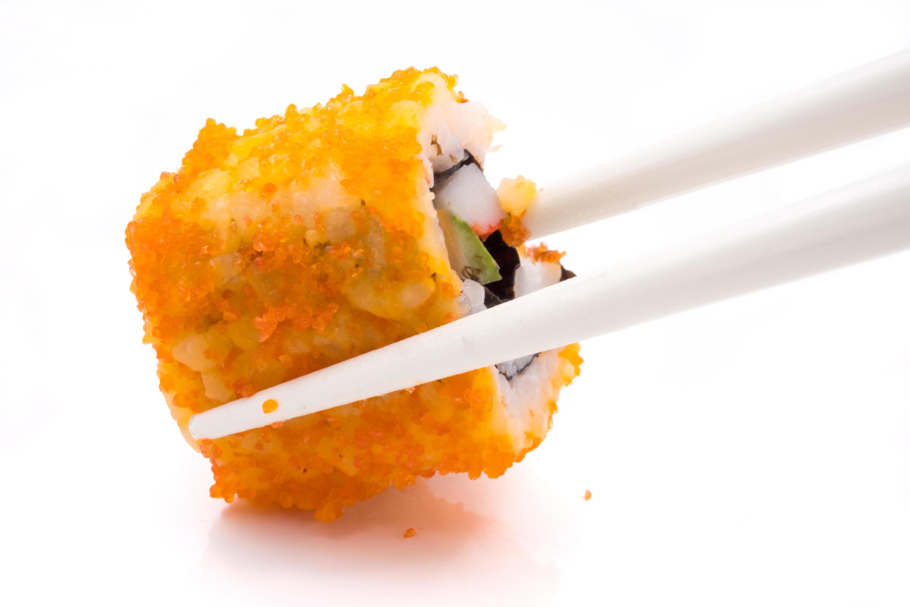 Sushi, japanese food, california roll with chopsticks on white background. Stock Free