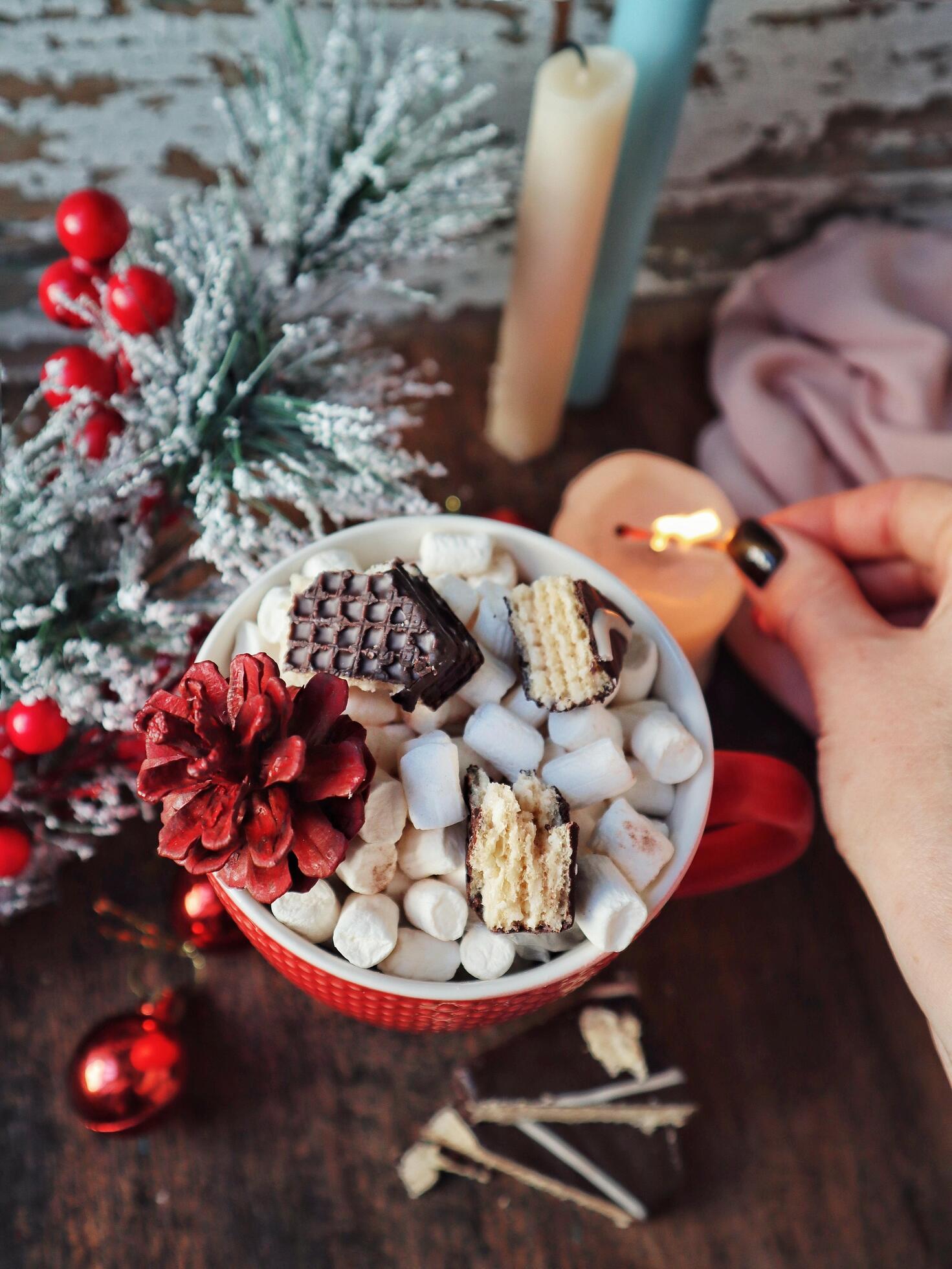 Cup of hot cocoa with marshmallows and cinnamon on a table with christmas decoration Stock Free