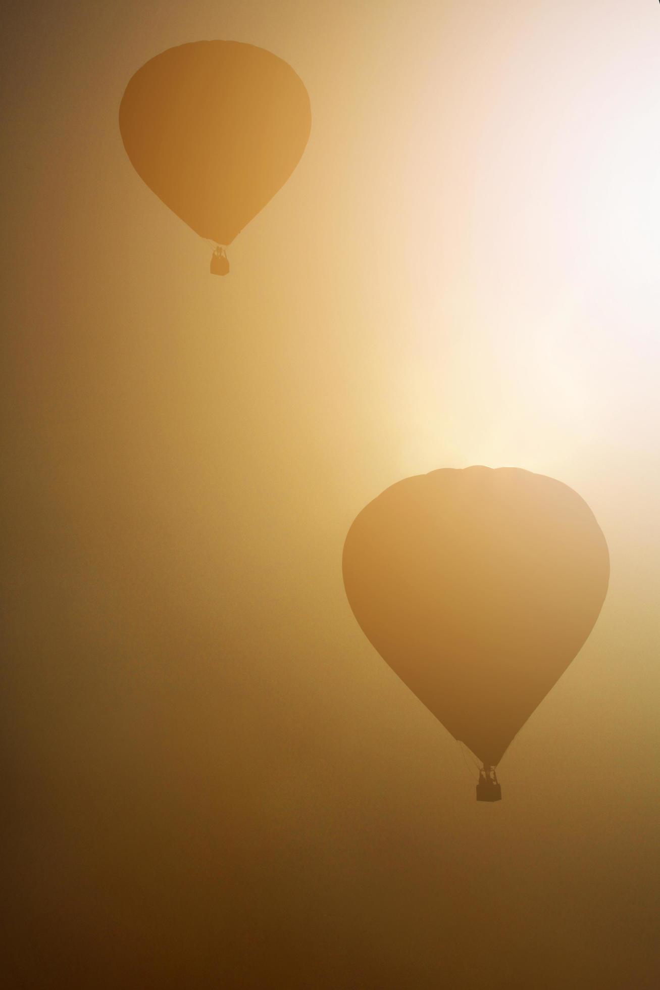 Beautiful Balloons free flying in the atmosphere of golden sunlight in the sky and Balloon Night Glow in Thailand International Balloon Festival. Stock Free