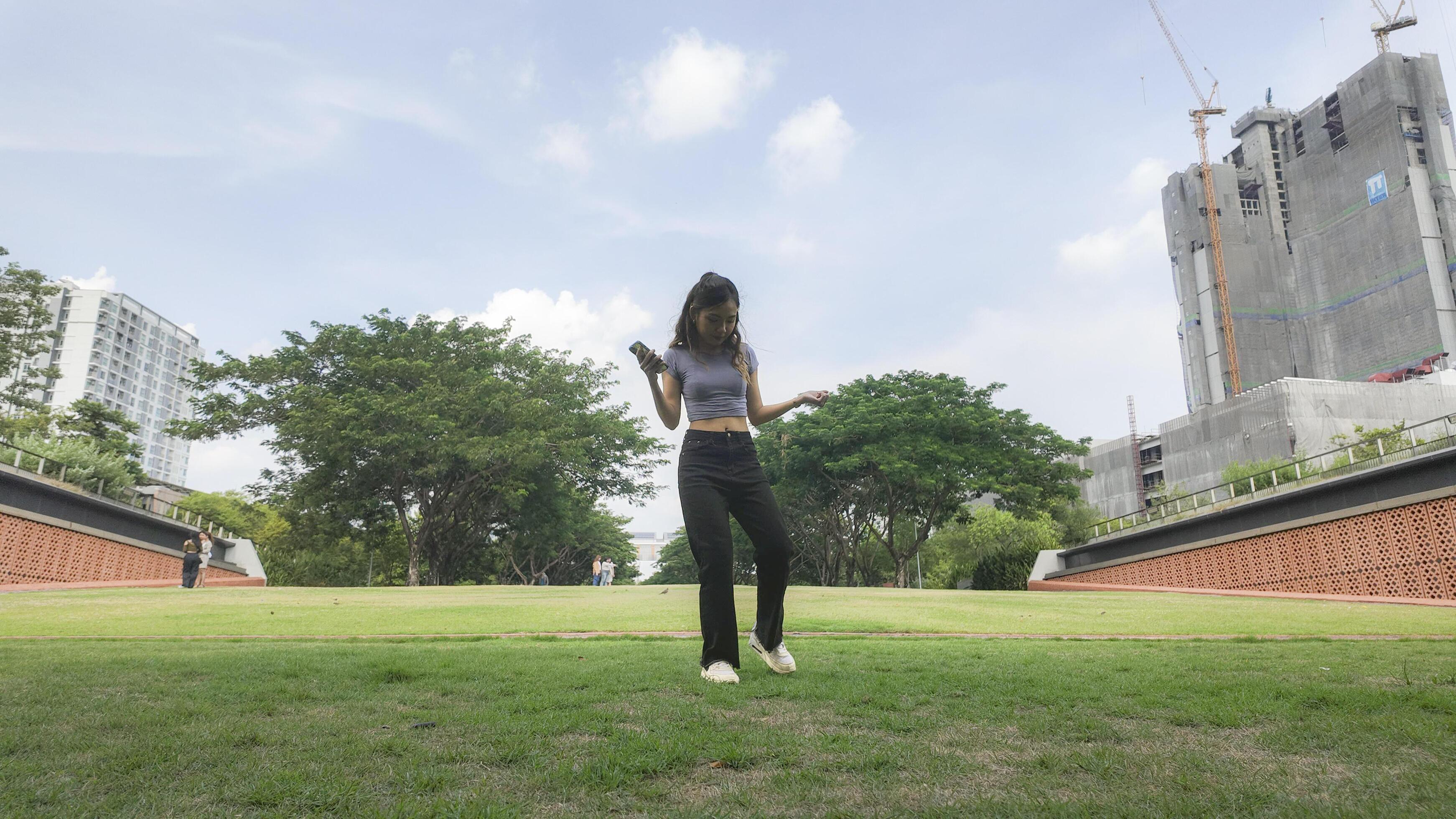 Asian women do freestyle hip hop and breakdancing in a public space in the middle of the city. With a cheerful and happy attitude Stock Free