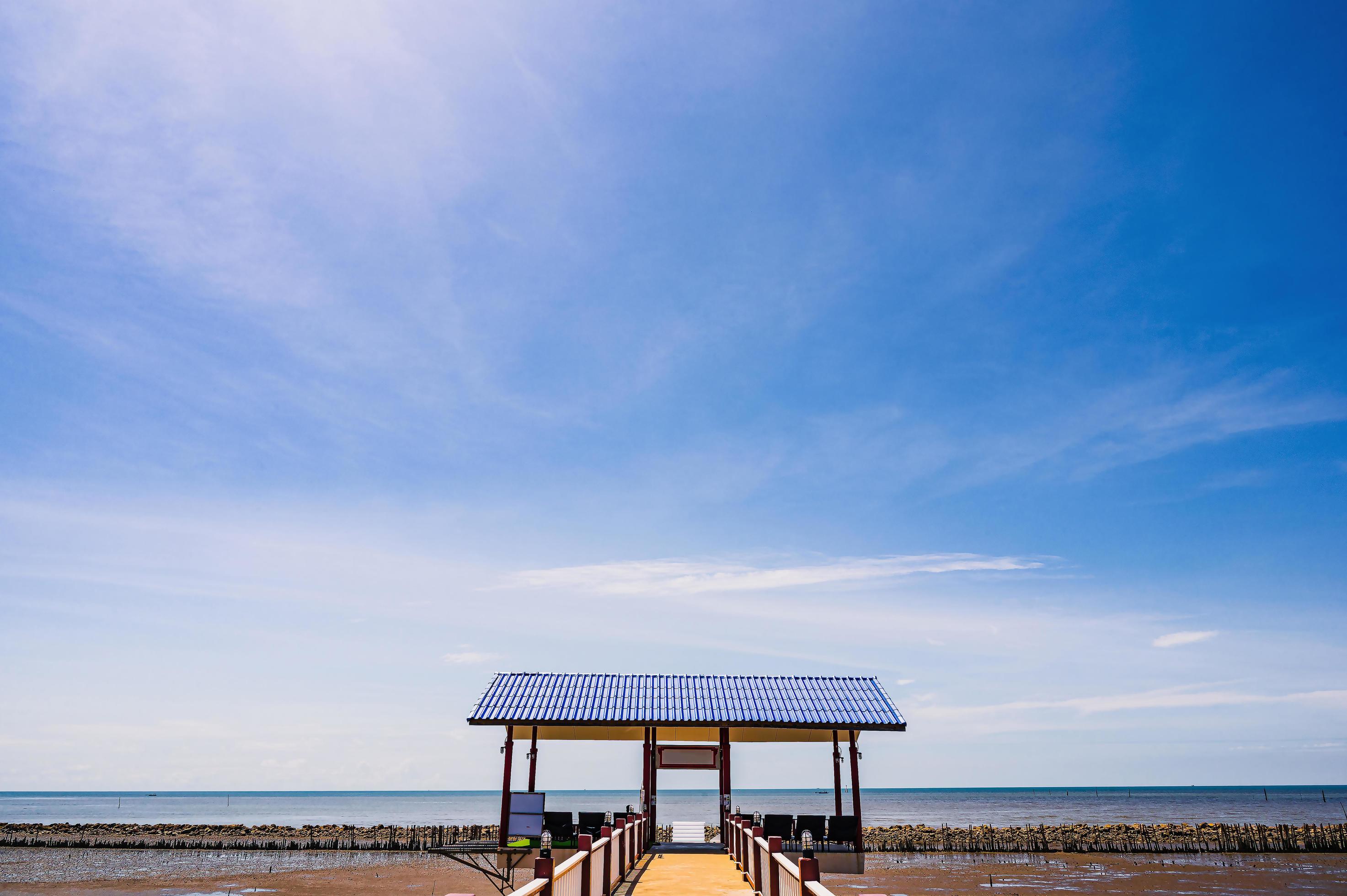 Beautiful seascape and blue sky with small building beside the sea in thailand. Stock Free