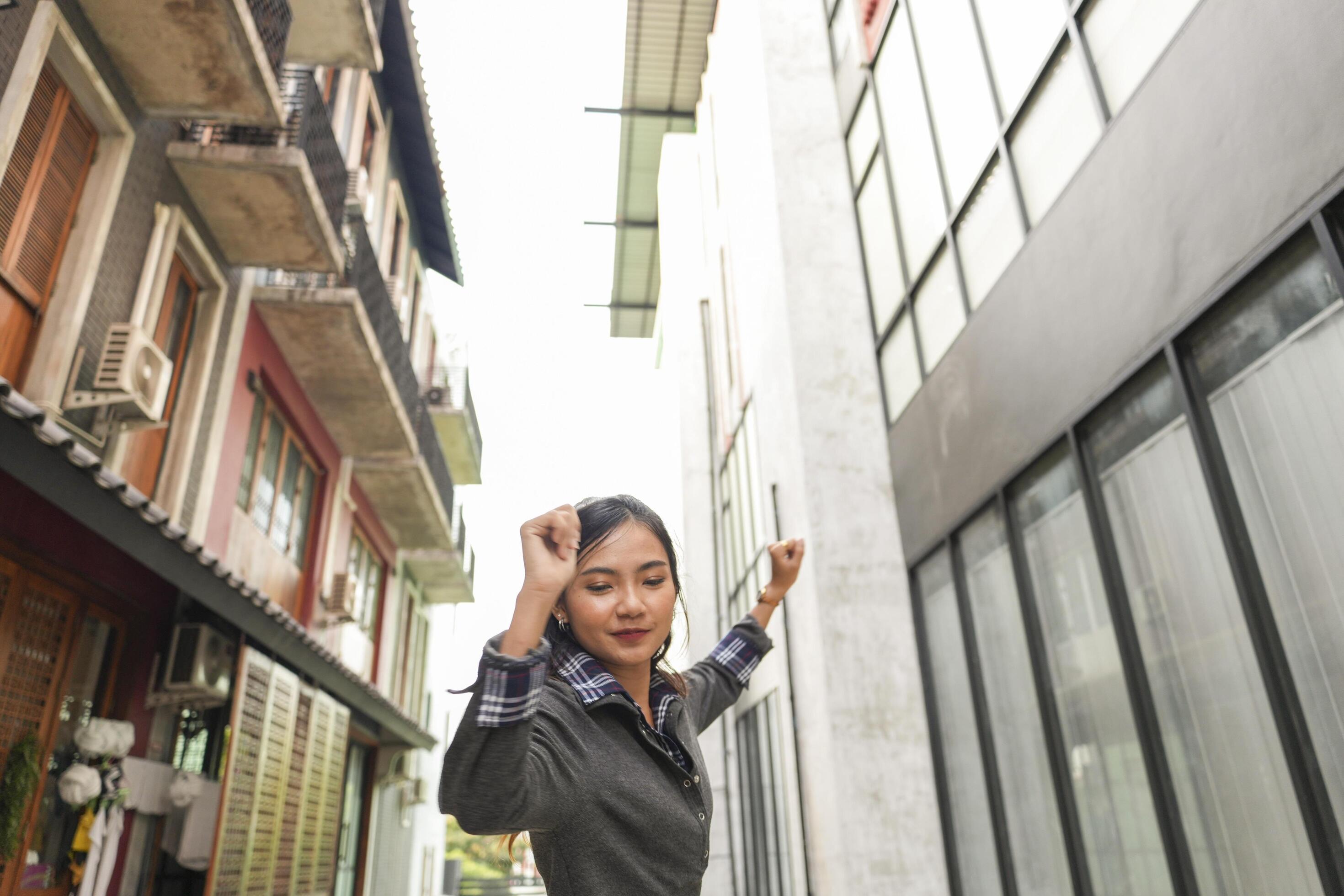 Asian women do freestyle hip hop and breakdancing in a public space in the middle of the city. With a cheerful and happy attitude Stock Free