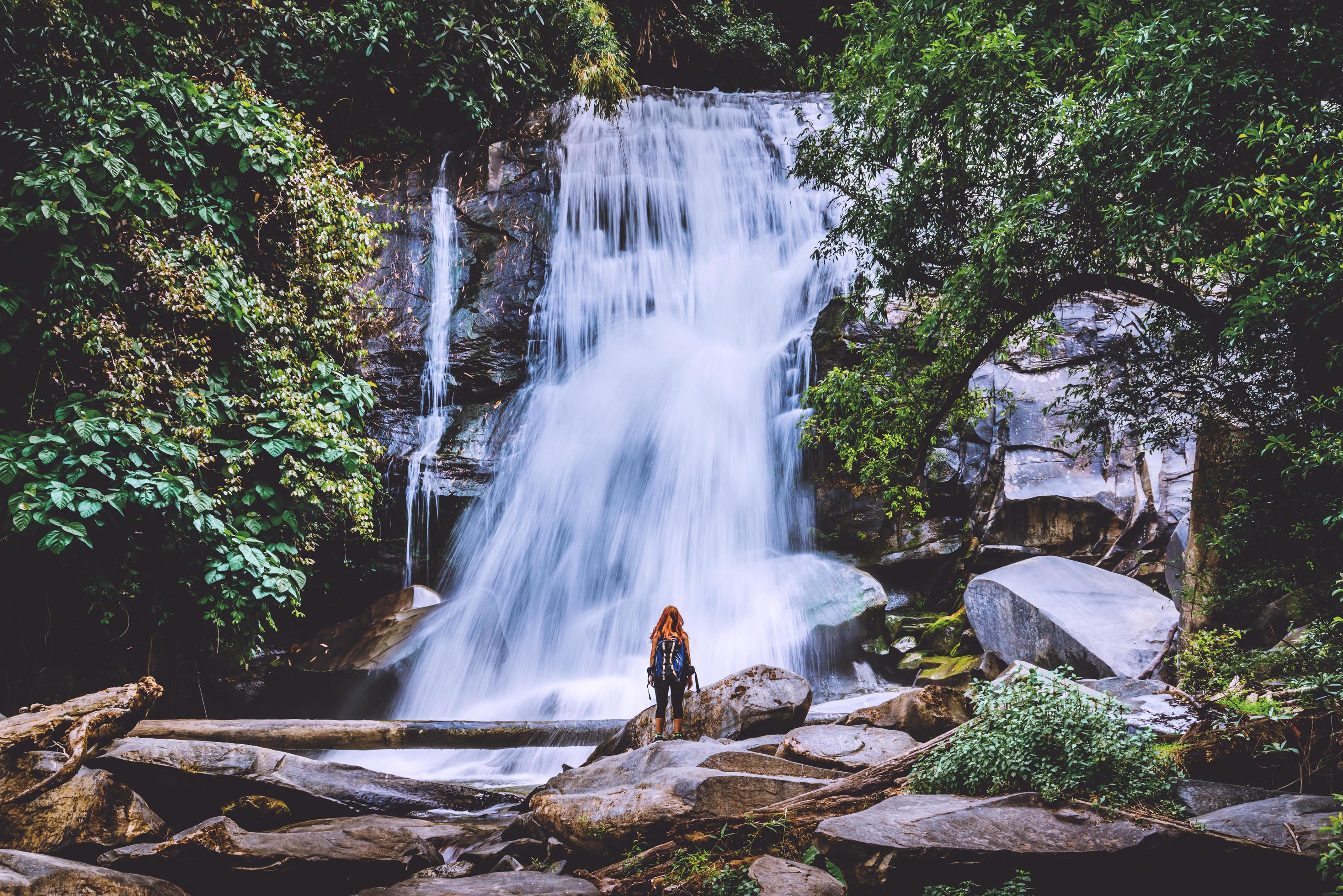 Women travel. woman asia travelers travel nature Forests, mountains, waterfalls. Travel Siliphum Waterfall at Chiangmai, in Thailand. Stock Free