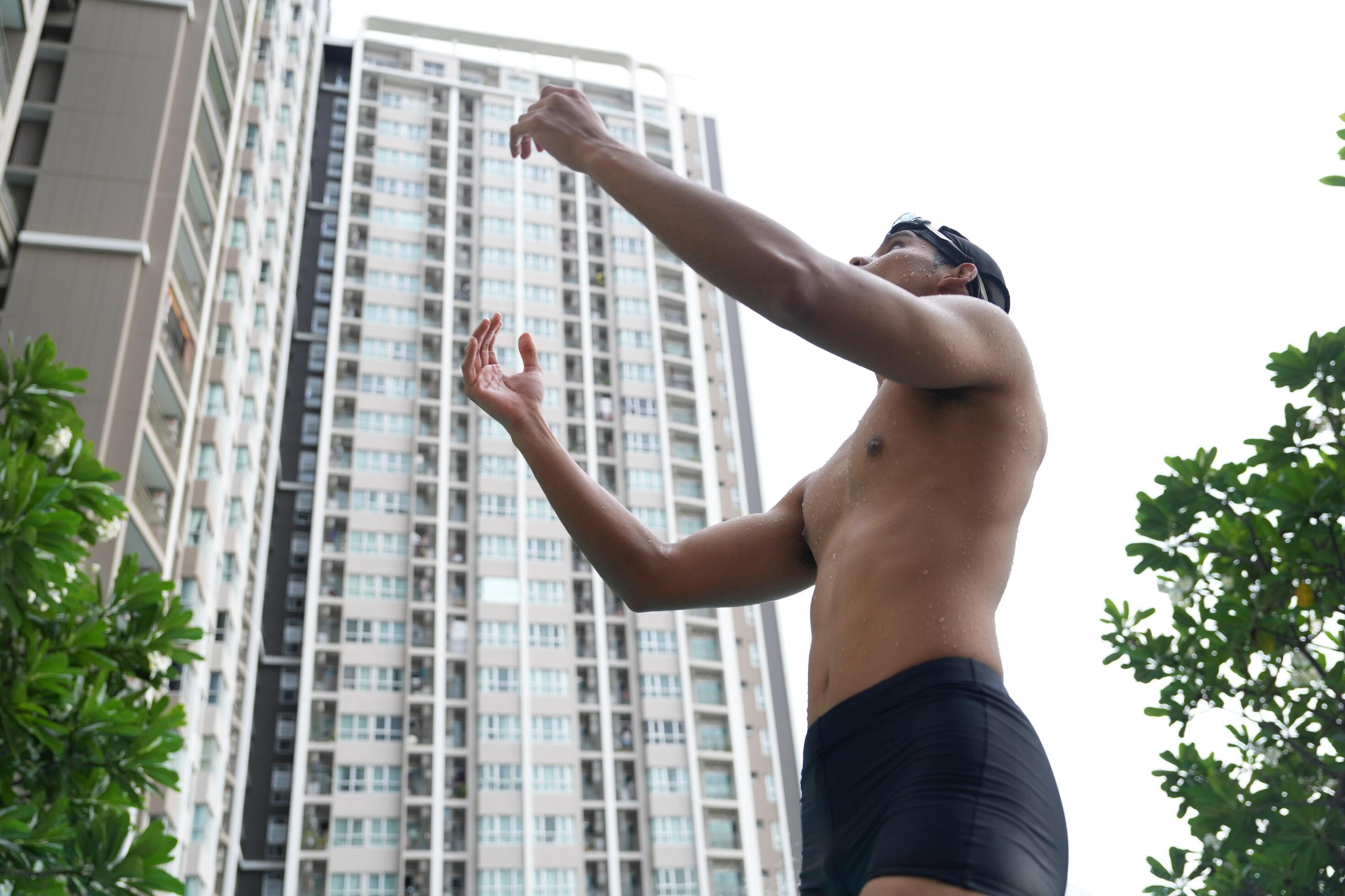 Asian men practicing swimming and preparing to play water polo and stretching and resting for water sports. Stock Free