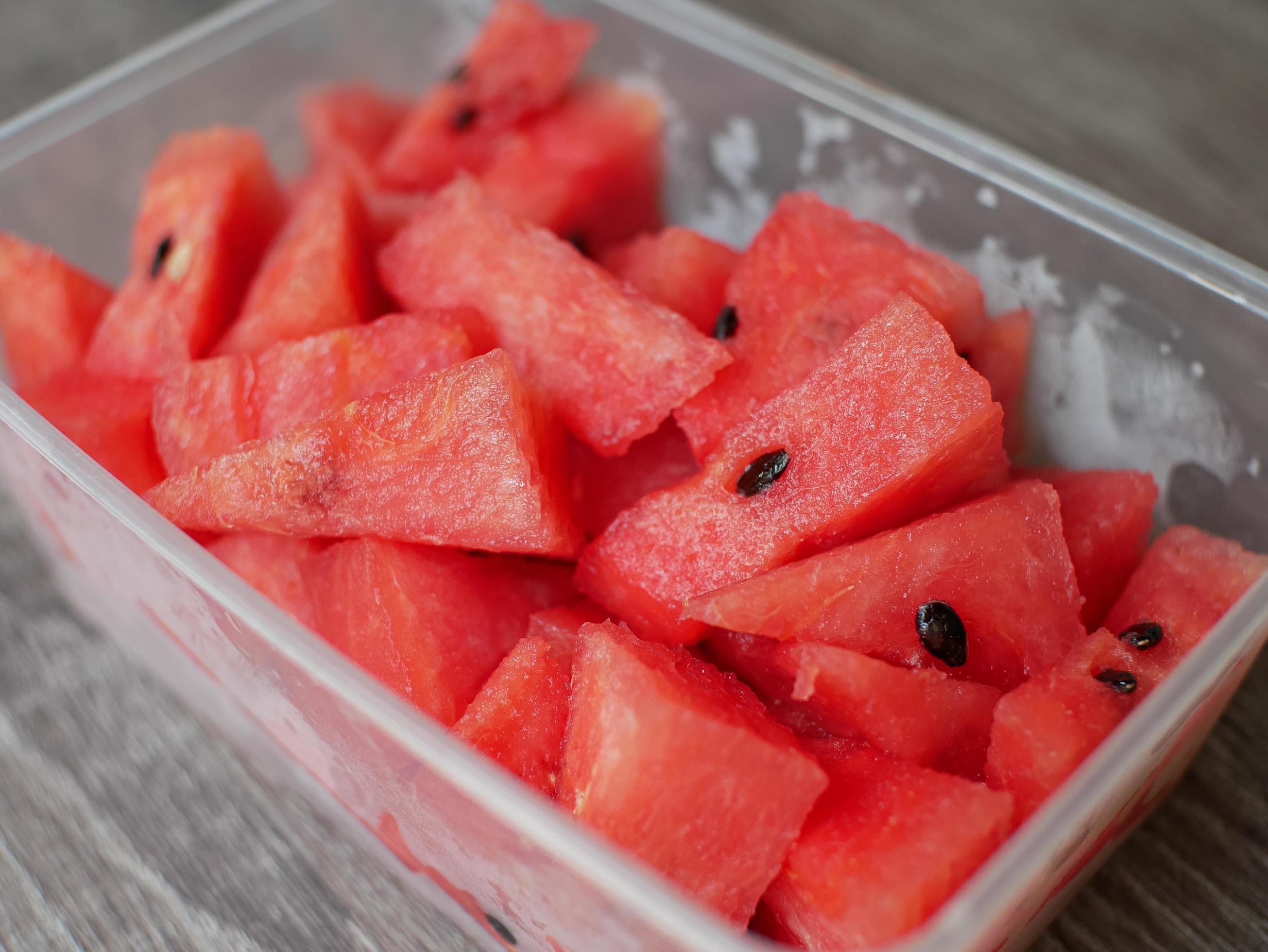 sliced fresh watermelon in a transparent container. healthy food and diet concept Stock Free