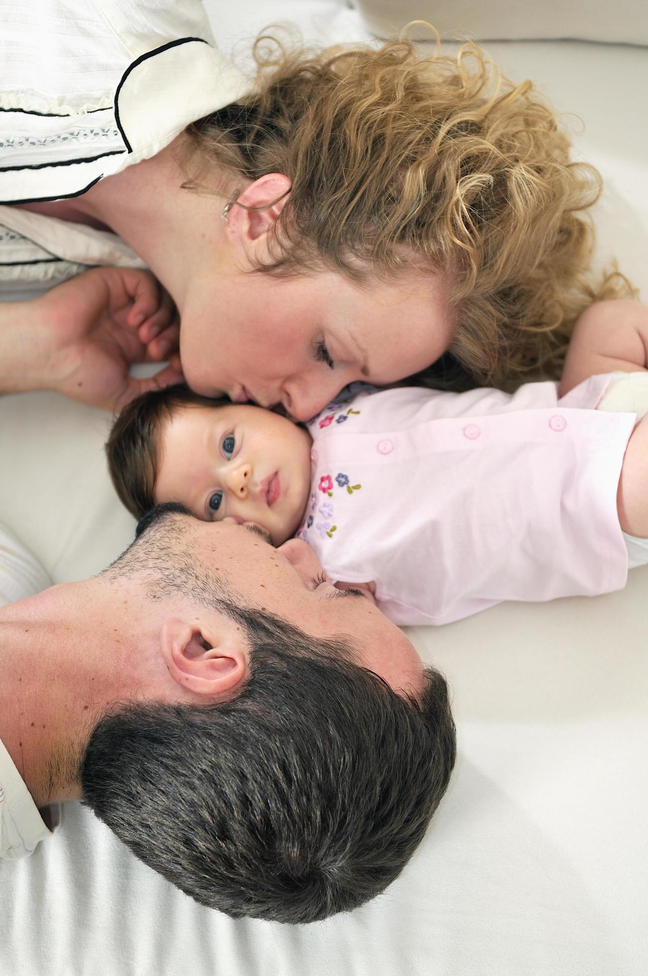 indoor portrait with happy young family and cute little babby Stock Free