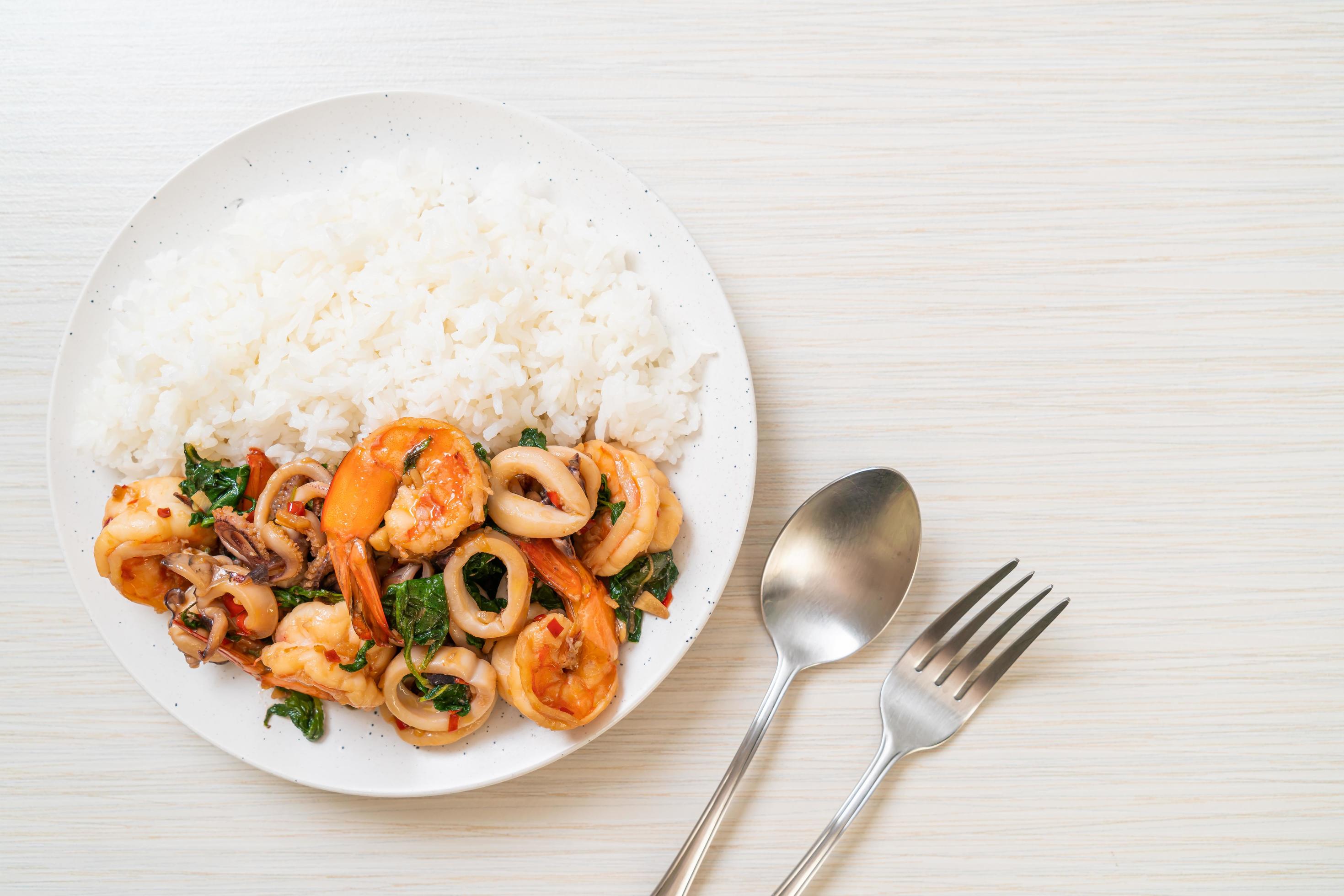 Rice and stir-fried seafood of shrimp and squid with Thai basil – Asian food style Stock Free