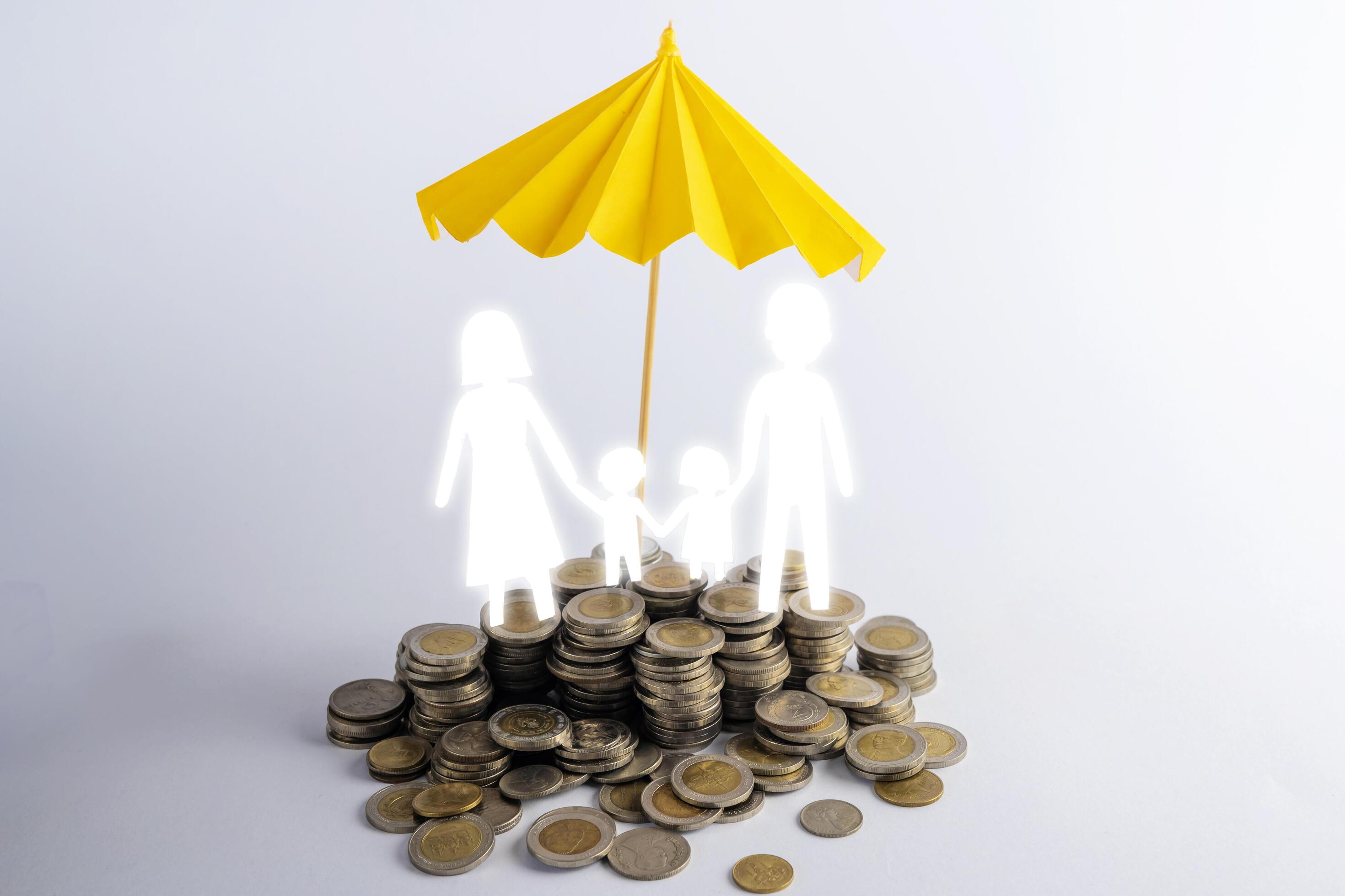 Coin stacks with family with the protect umbrella on dark background , business idea and insurance concept Stock Free