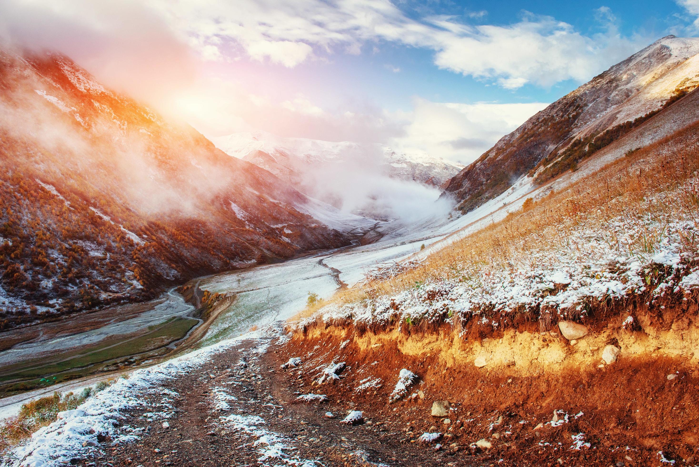 Mountain landscape of snow-capped mountains in the mist Stock Free