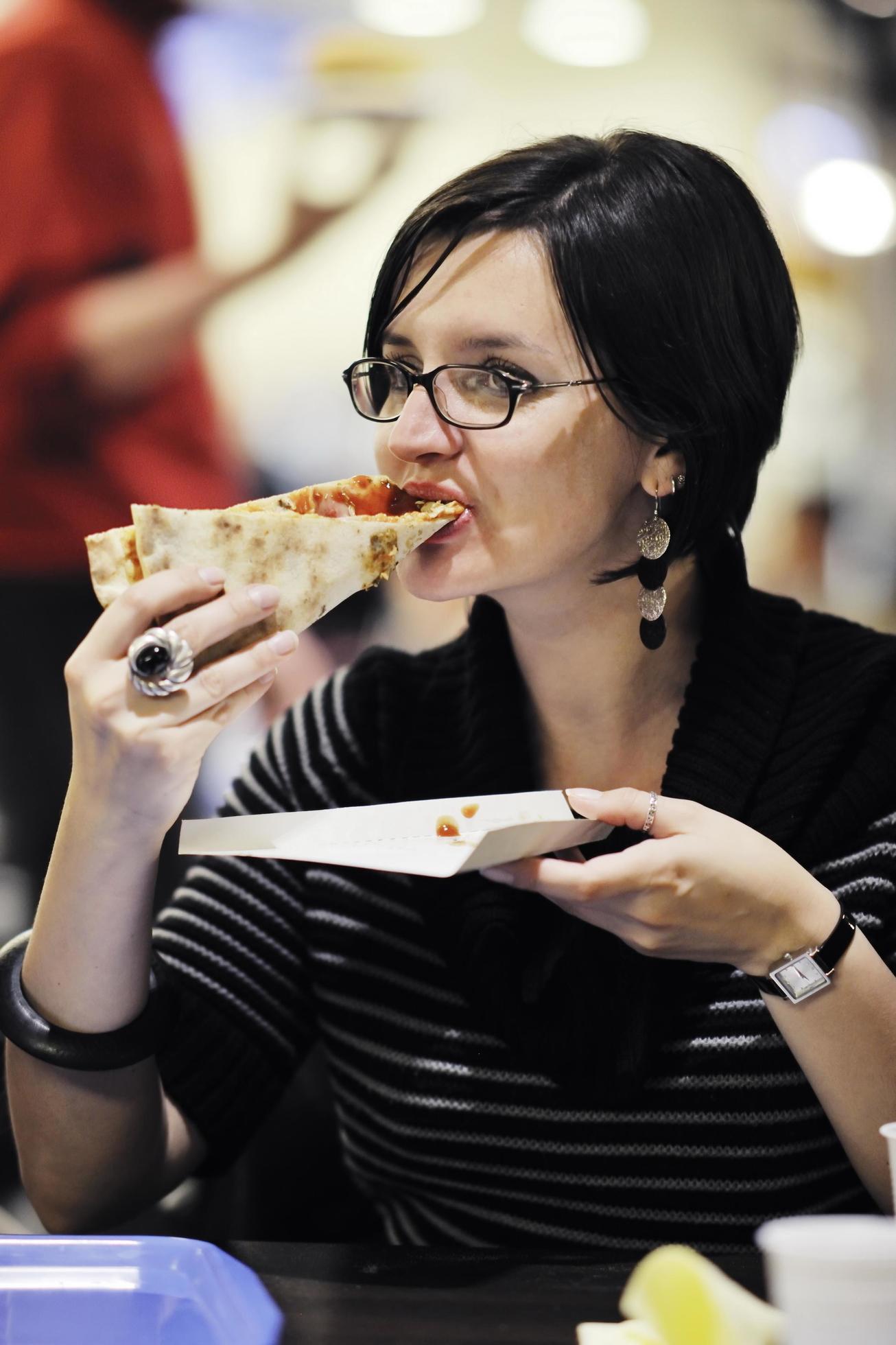 woman eat pizza food at restaurant Stock Free