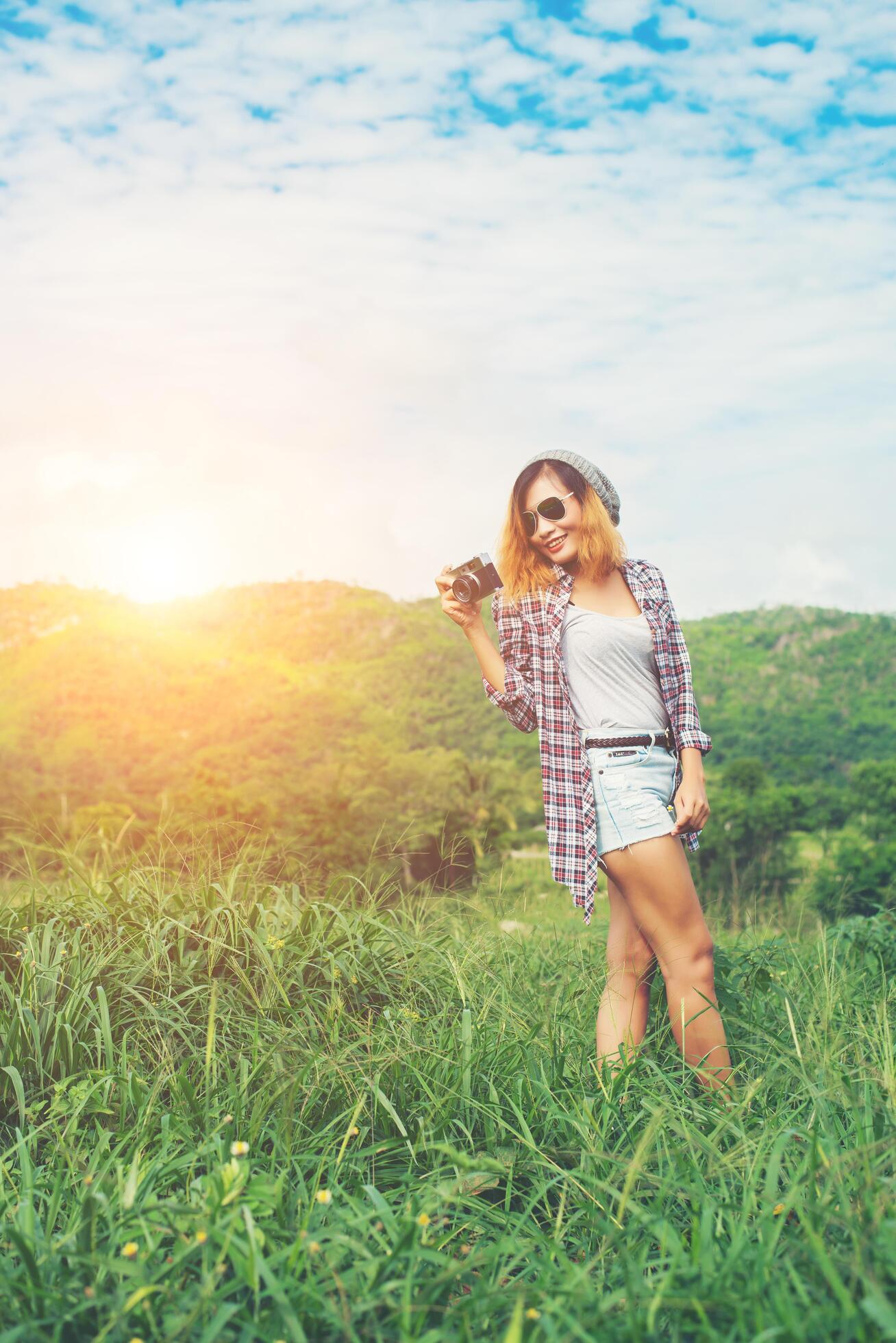 Young Hipster Woman with retro camera taking shot outdoor landscape ,Lifestyle mountain nature on background. Stock Free