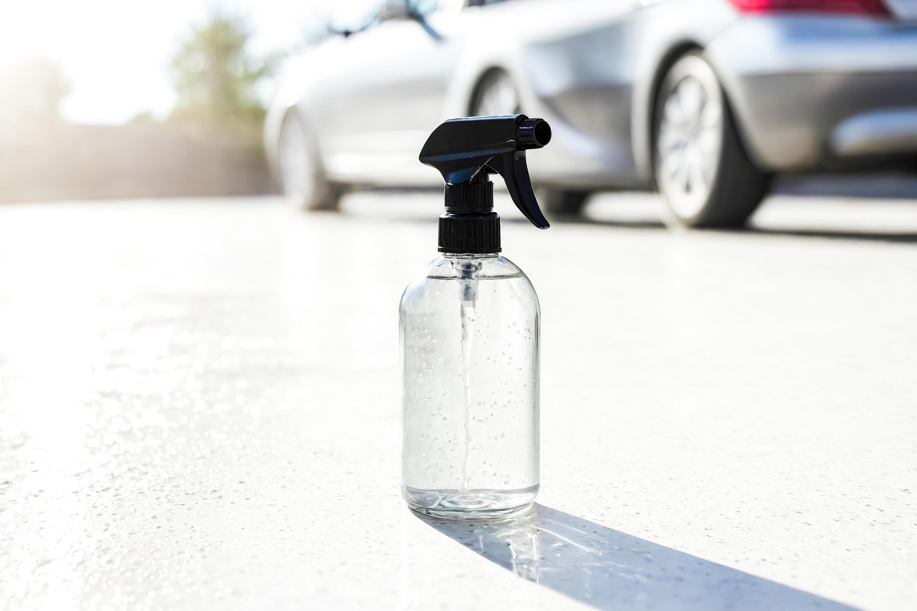 Car Cleaning Spray Bottle with Car in Background Stock Free