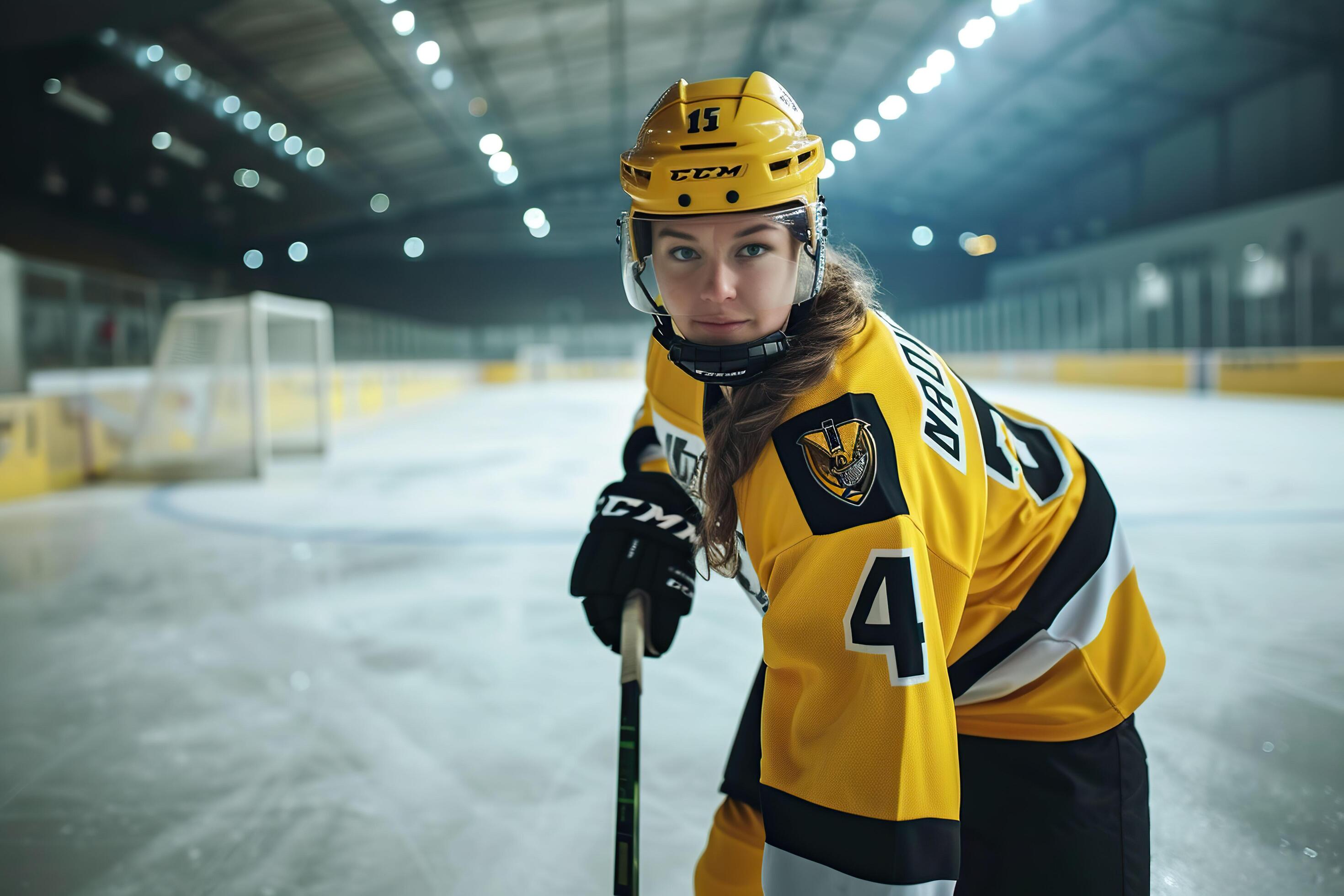 Young woman ice hockey player in sport arena. Stock Free