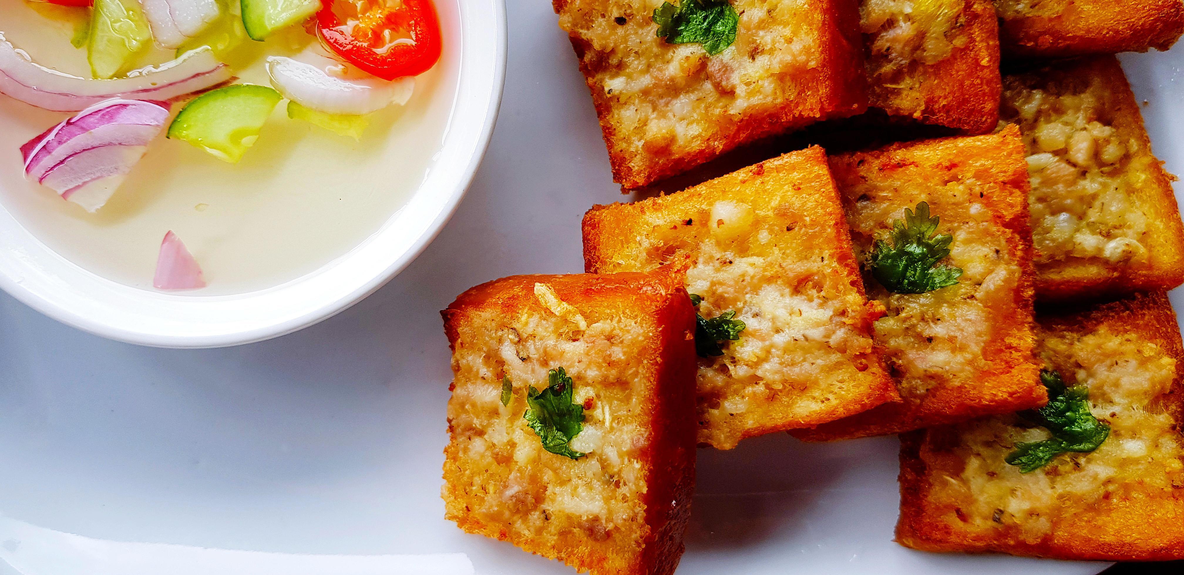 Close up deep fried minced pork toast with sour sauce on white dish or plate. Thai food or snack concept. Stock Free