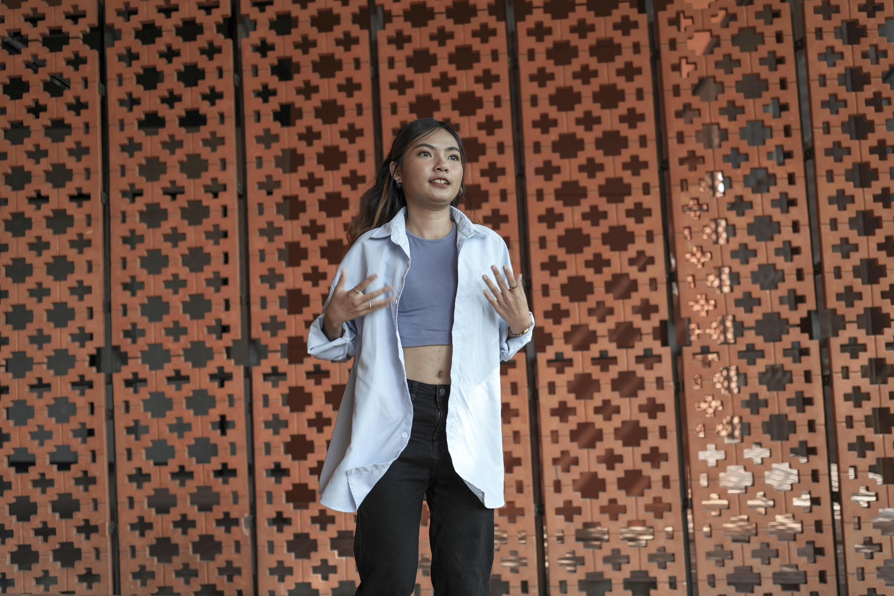 Asian women do freestyle hip hop and breakdancing in a public space in the middle of the city. With a cheerful and happy attitude Stock Free