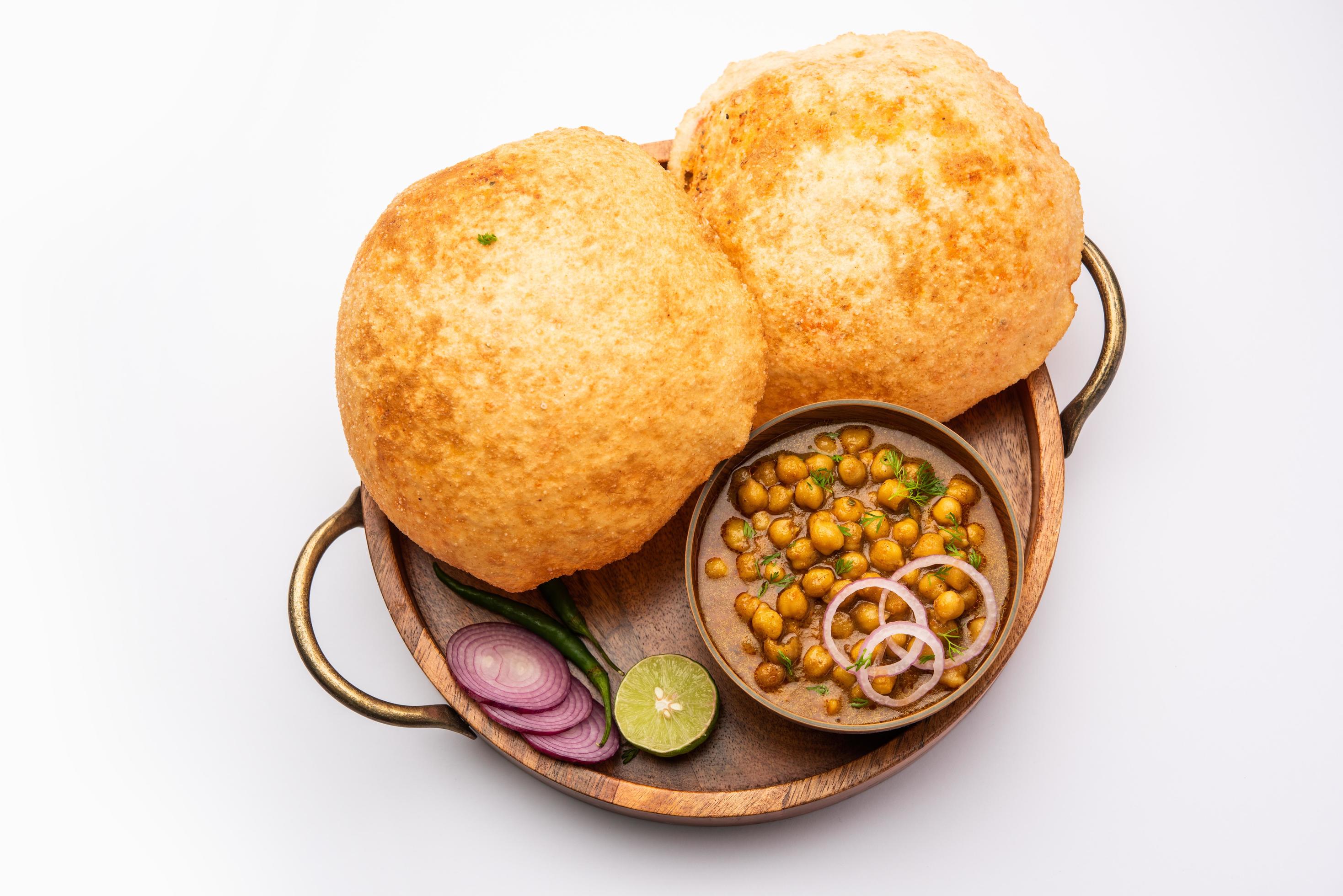 Chole bhature is a North Indian food dish. A combination of chana masala and bhatura or puri Stock Free