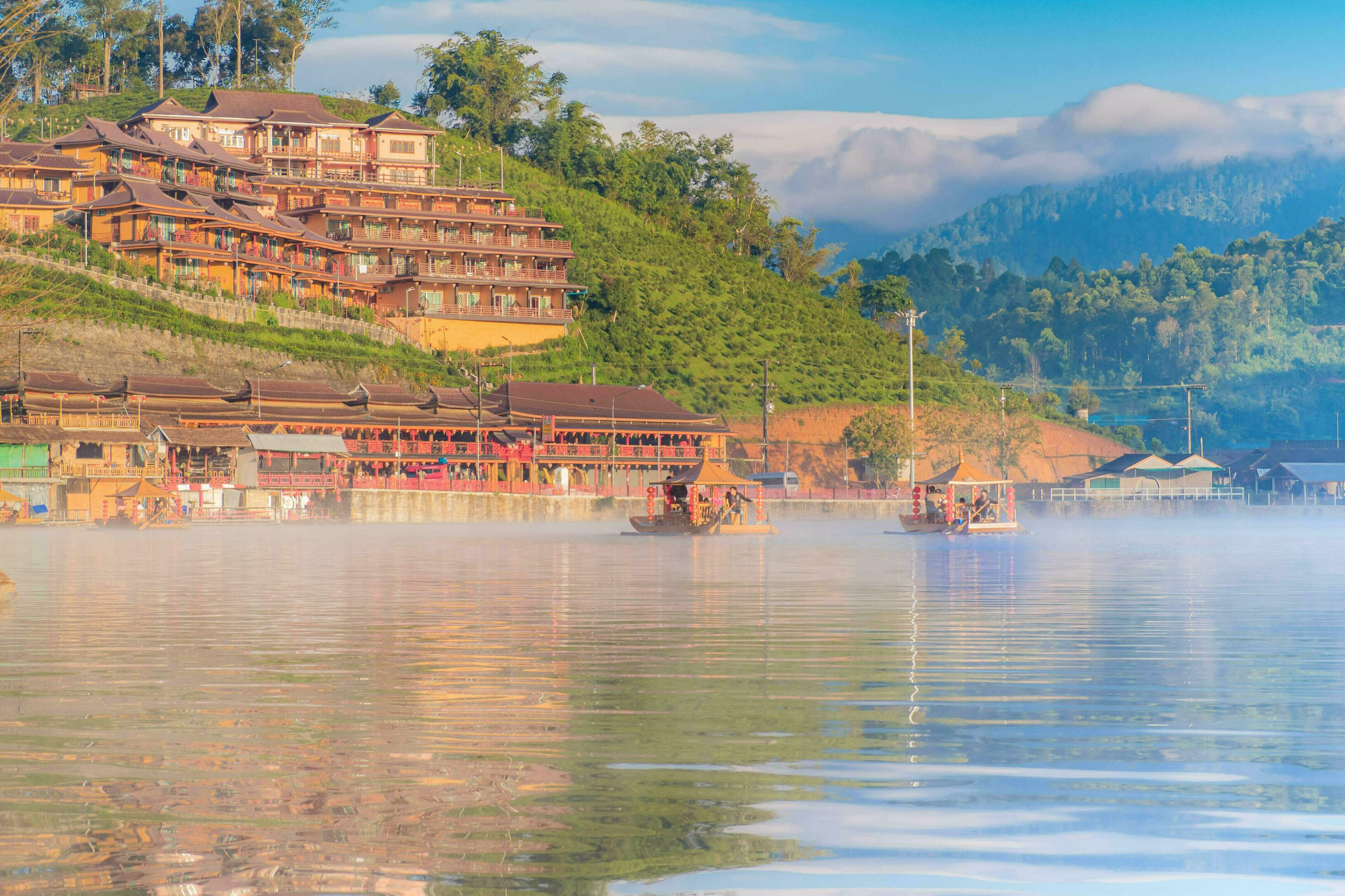 Chinese boat launched early in the morning at Rak Thai hamlet in Maehongson, Thailand, on the lake with water vapor, Banrakthai, Ban rak thai. Stock Free