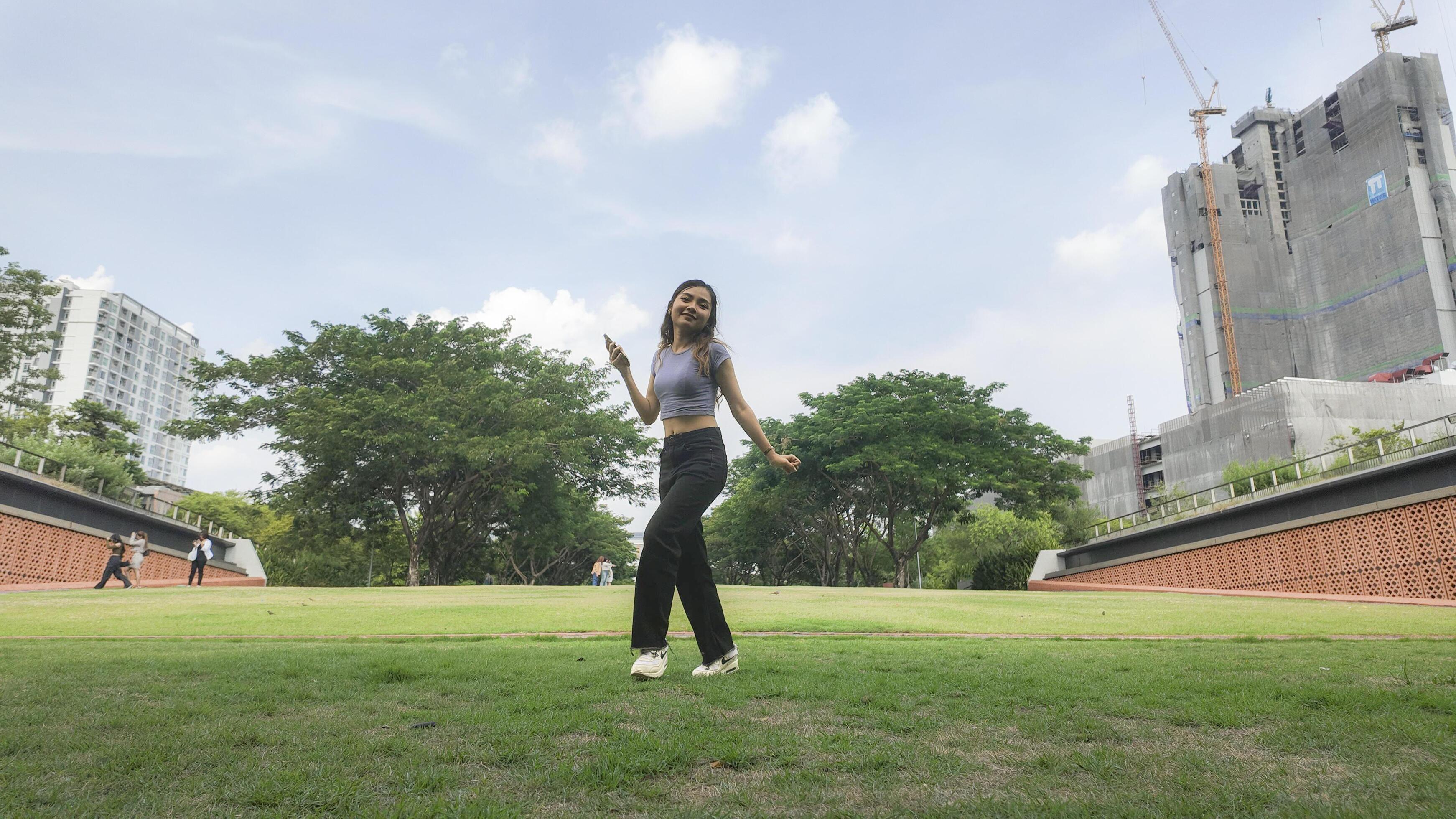 Asian women do freestyle hip hop and breakdancing in a public space in the middle of the city. With a cheerful and happy attitude Stock Free