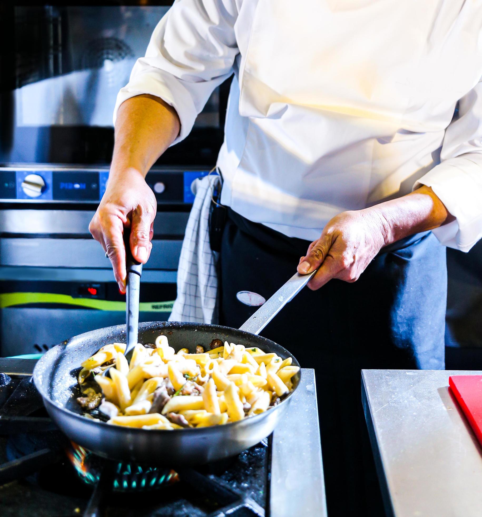 Chef preparing food in the kitchen, chef cooking, closeup Stock Free