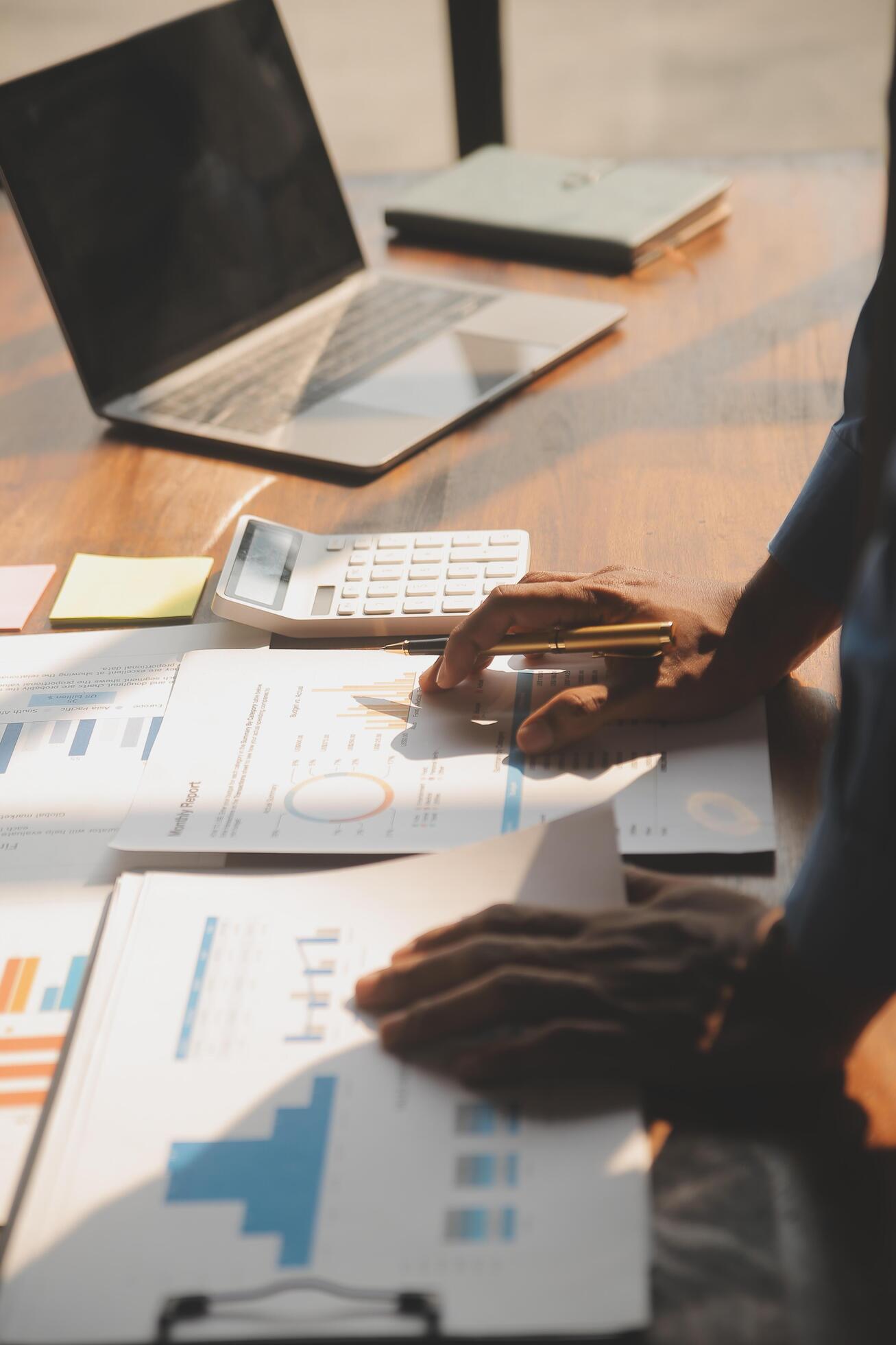 Close up of Business team analyzing income charts and graphs with modern laptop computer. Business analysis and strategy concept. Stock Free