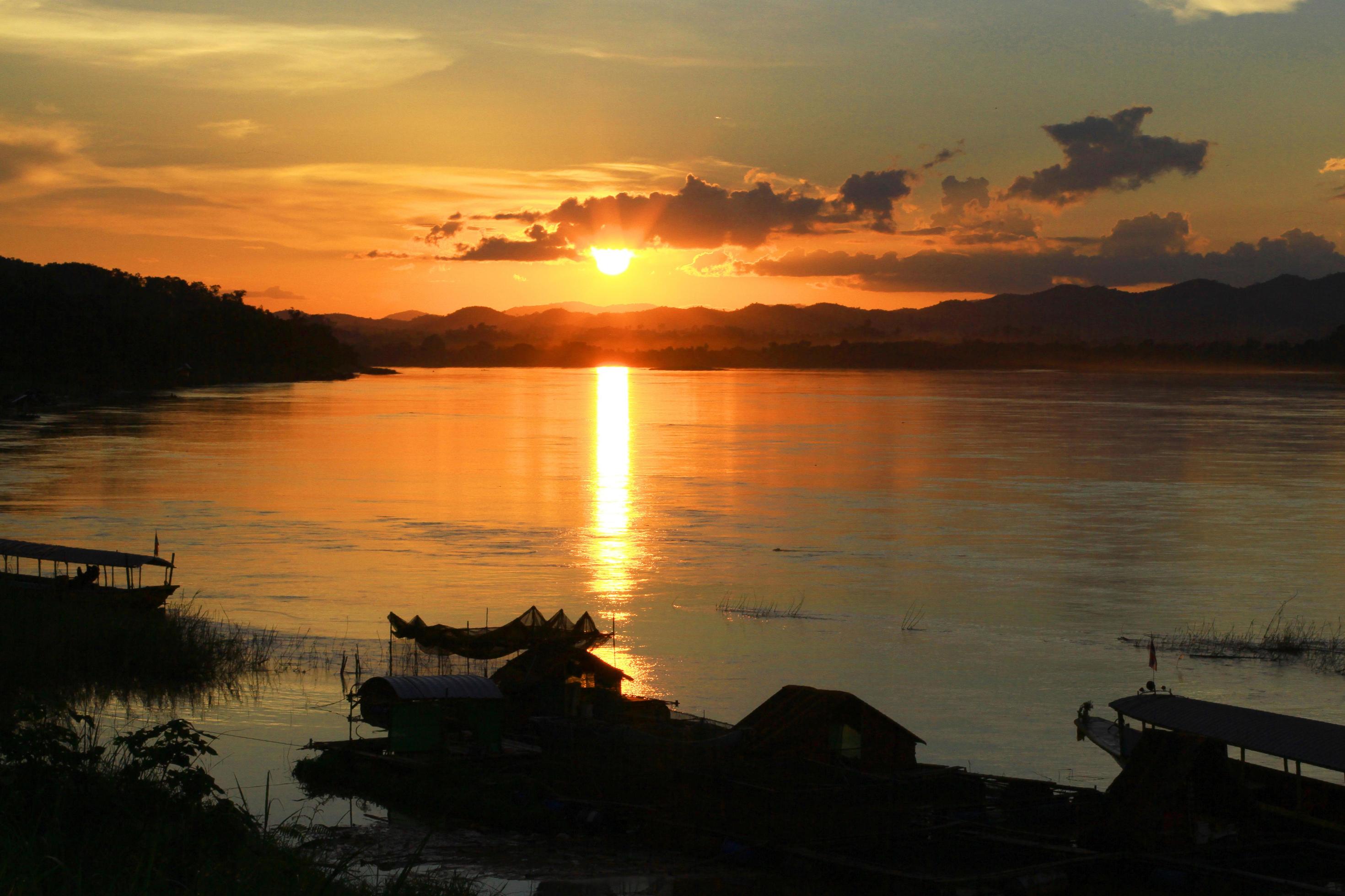 Tradition of Long tail boat and fisherman in beautiful sunset twilight at Khong river the Thai-Laos border Chaingkhan distric Thailand Stock Free