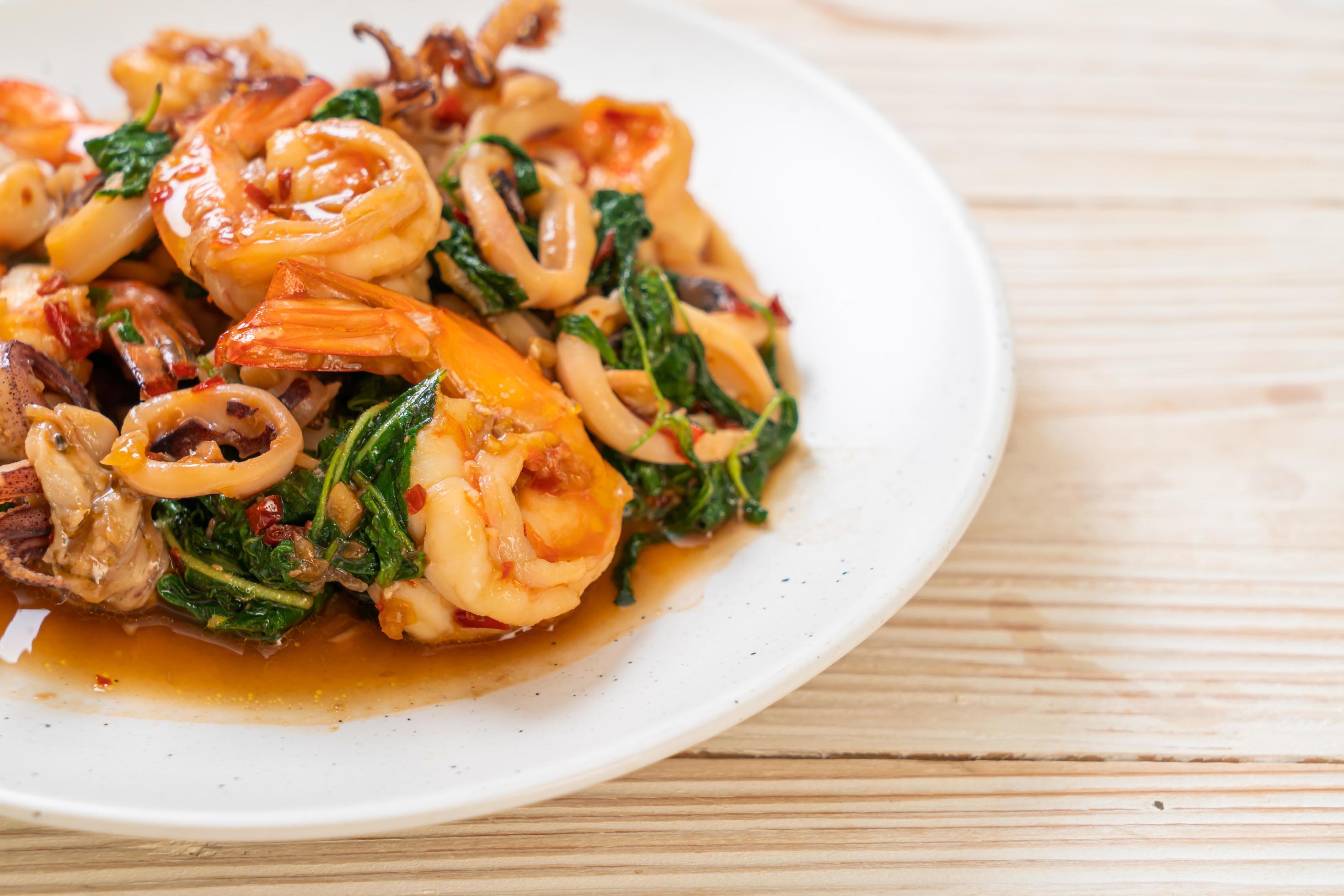 Stir-fried seafood of shrimp and squid with Thai basil – Asian food style Stock Free