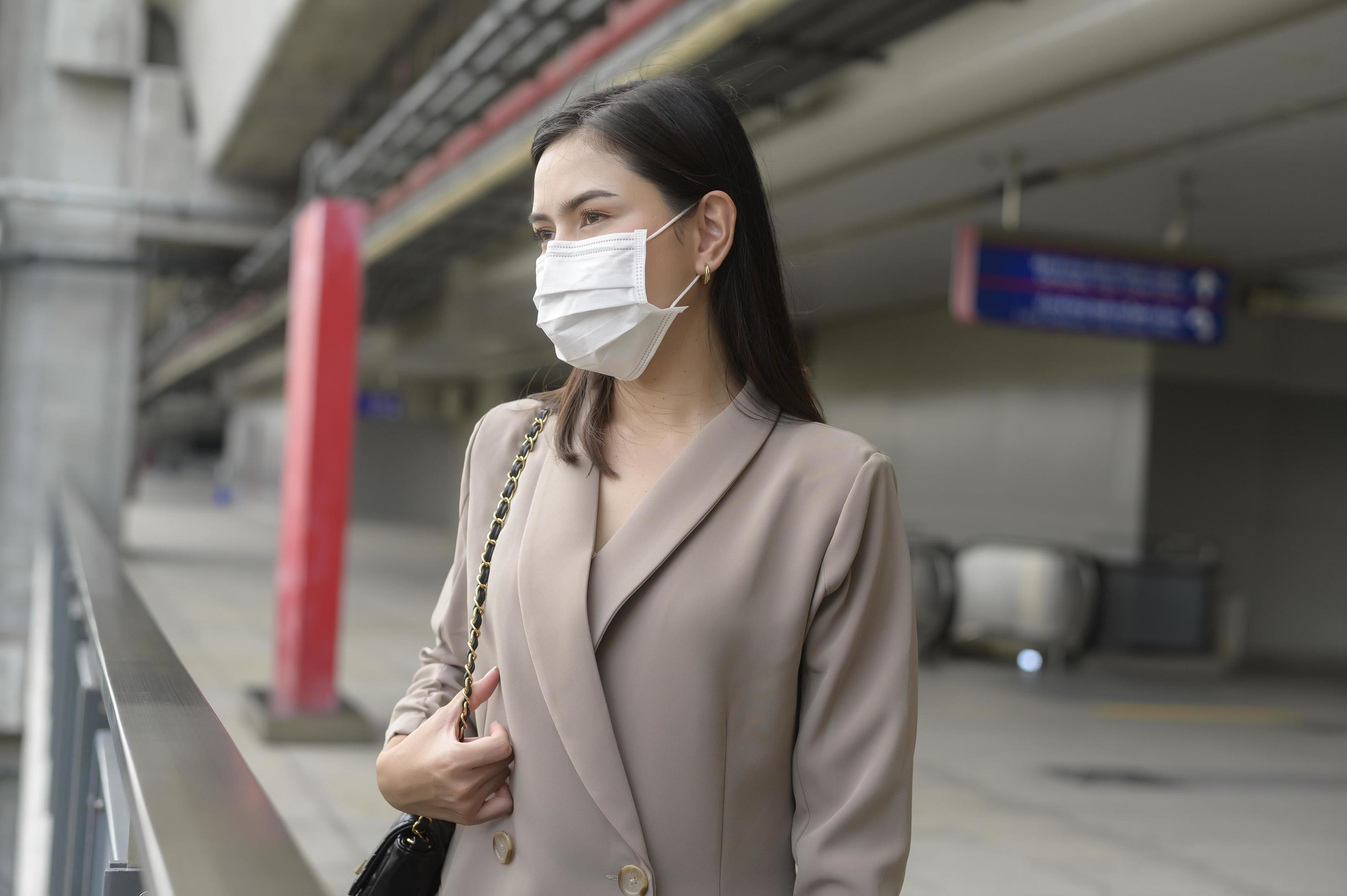 A portrait of Businesswoman is wearing face mask work in modern City , people lifestyle , working under Covid-19 pandemic concept Stock Free