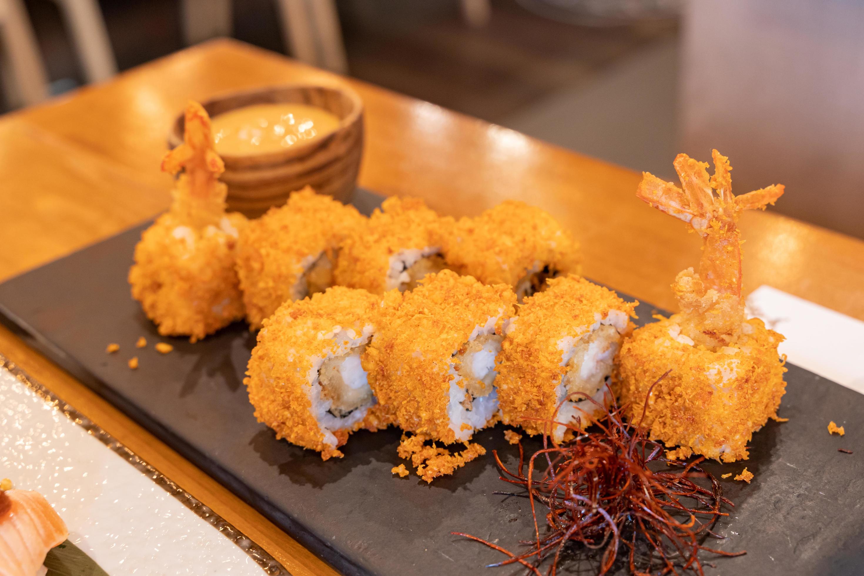 Tempura Maki, Fried Prawn or shrimp Sushi roll, on slate. Japanese traditional fusion food style, restaurant menu. Close up photo with selective focus. Stock Free