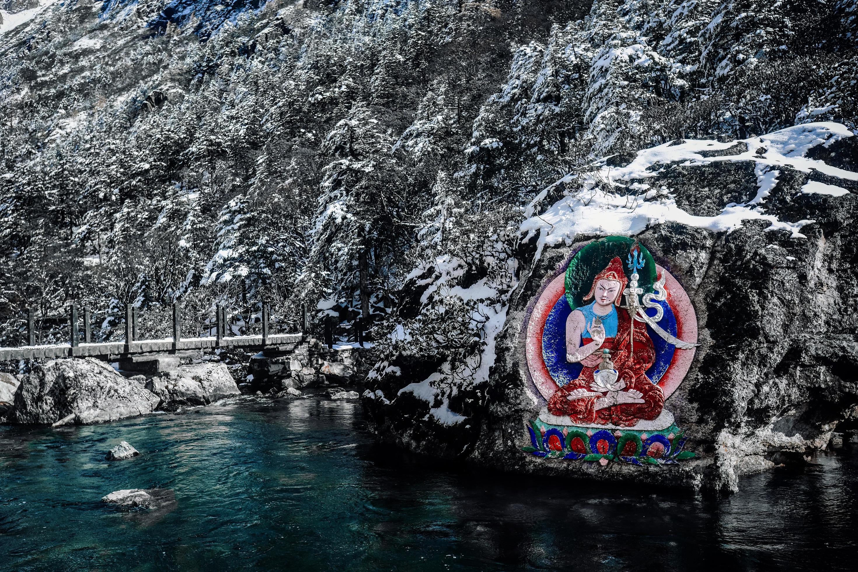 Stone carvings and paintings of Tibetan Buddha statues in the mountains of western Sichuan, China Stock Free